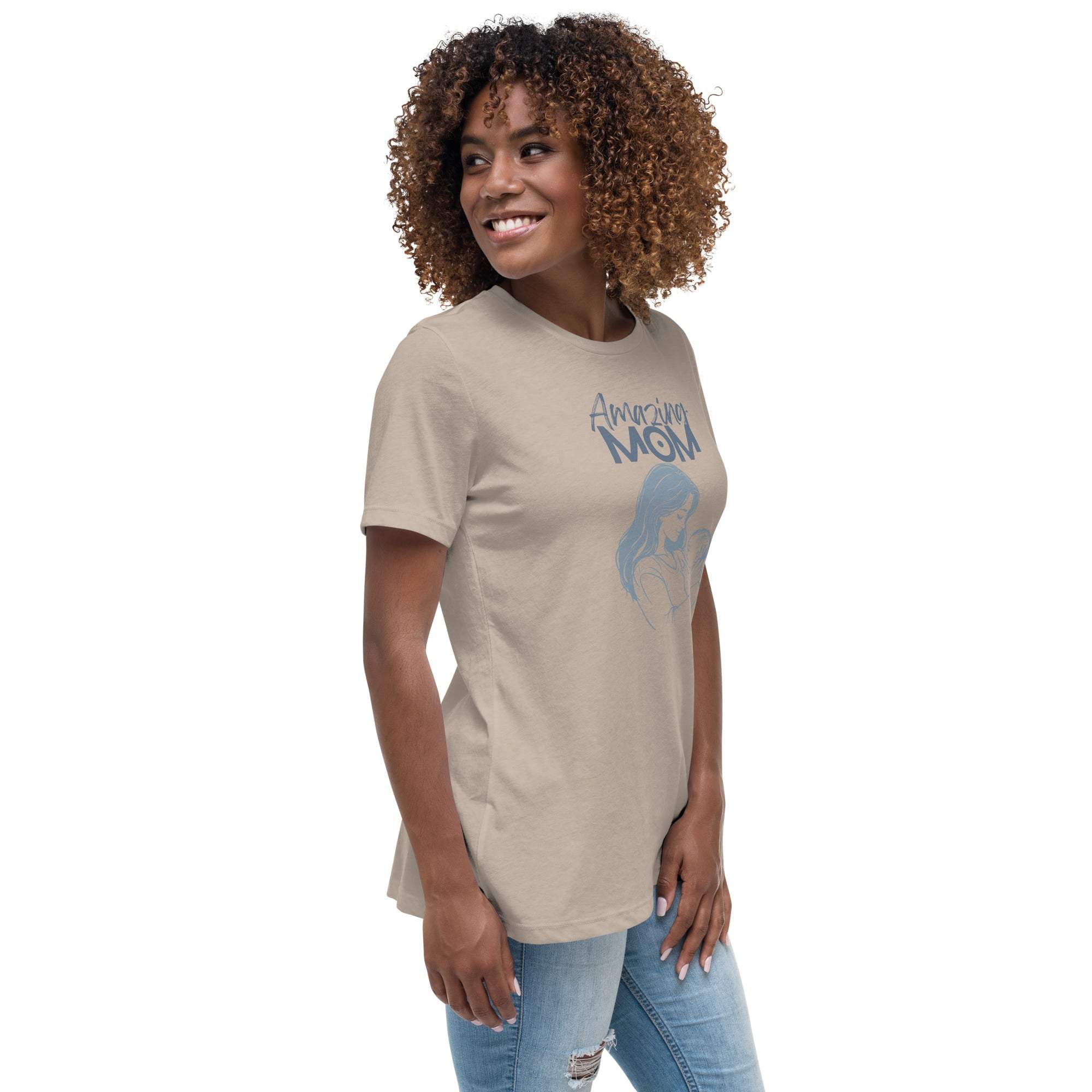 Woman wearing a beige "Amazing Mom" t-shirt with a blue graphic design, styled casually with jeans