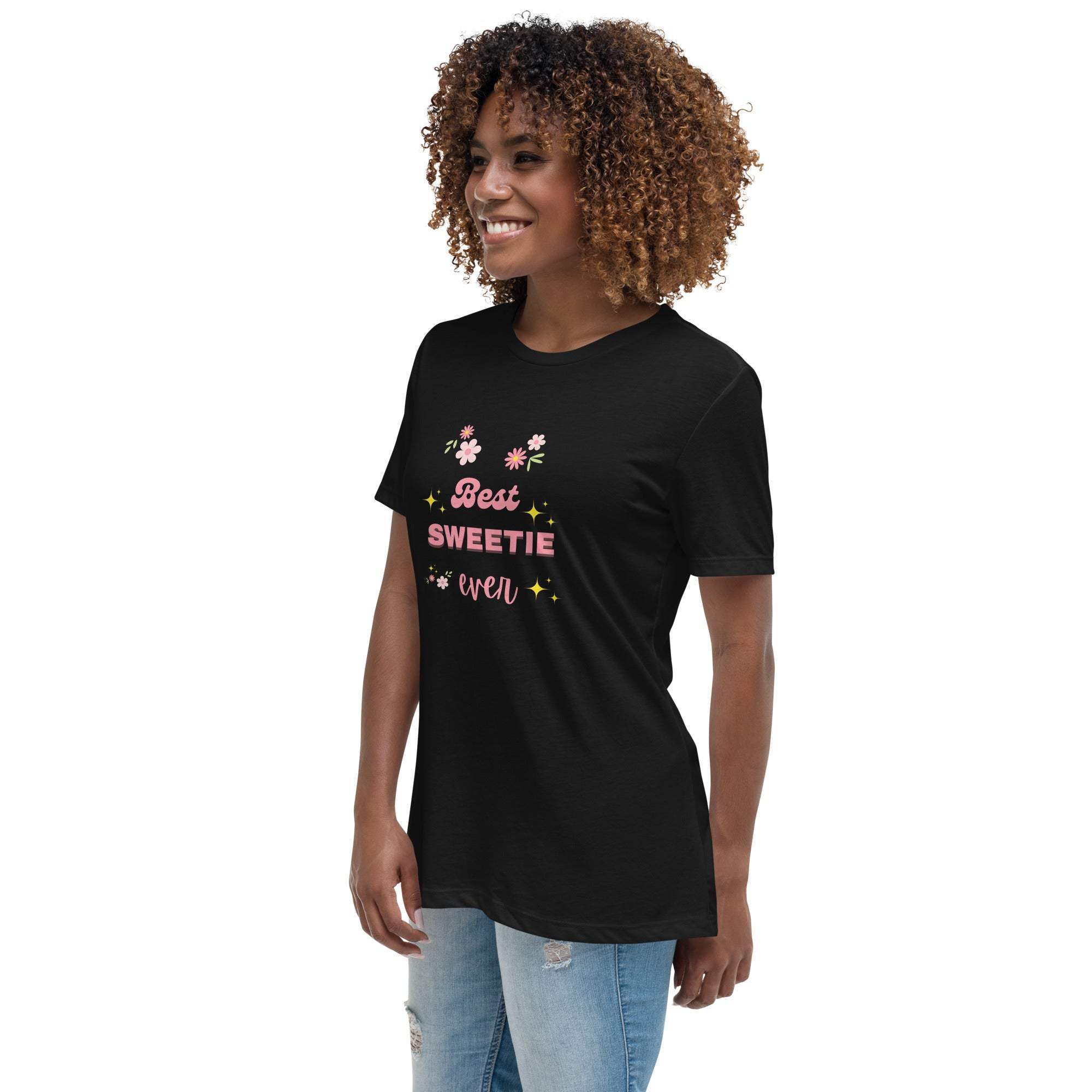 Woman wearing black Best Sweetie Ever t-shirt with floral and star design paired with ripped light blue jeans