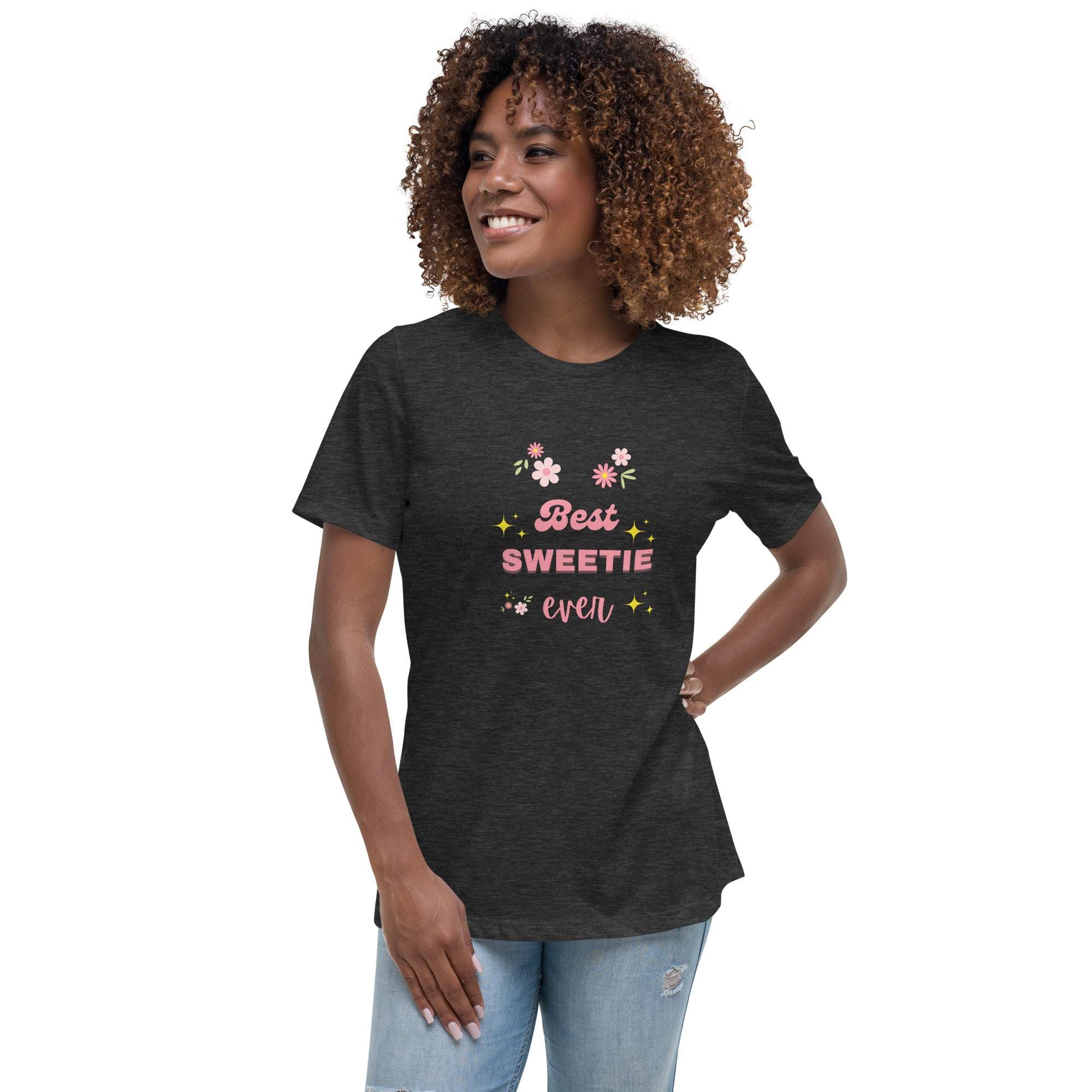 Woman wearing a black "Best Sweetie Ever" t-shirt with floral and star designs, paired with light blue jeans.