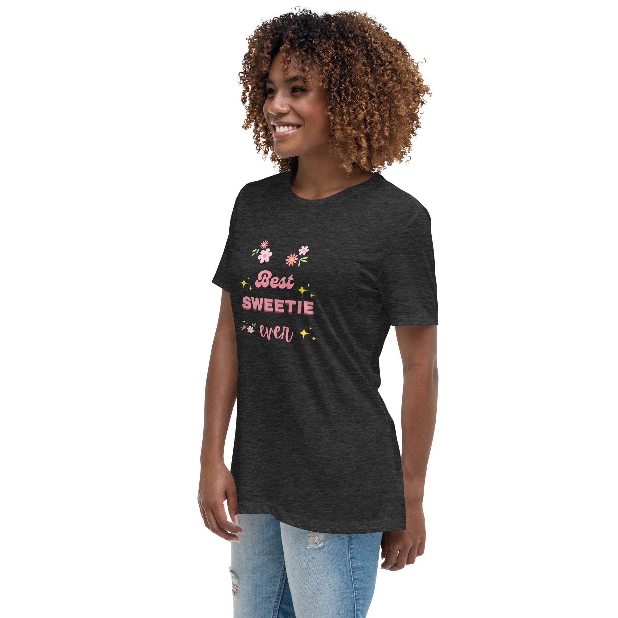 Woman wearing a black "Best Sweetie Ever" t-shirt with floral and star designs, paired with ripped jeans.