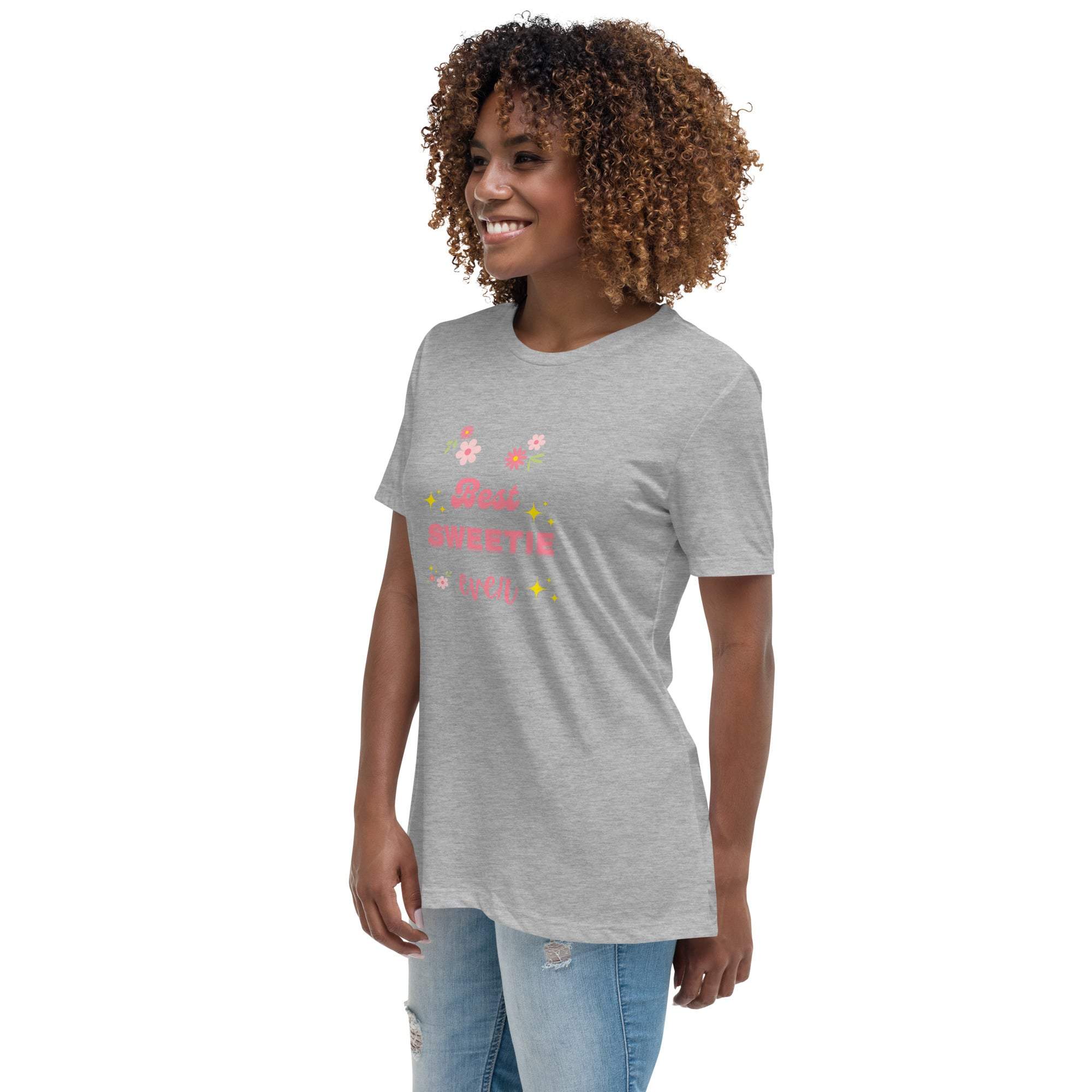 Woman wearing a grey "Best Sweetie Ever" t-shirt with floral and star design, paired with ripped jeans