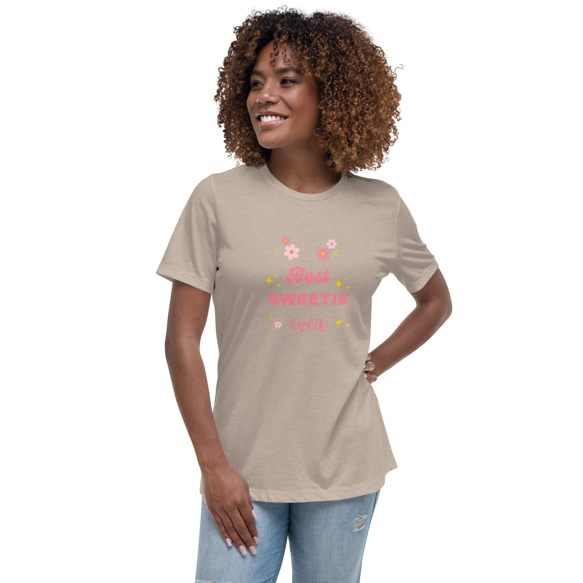 Woman wearing beige Best Sweetie Ever t-shirt with floral and star design and light blue jeans