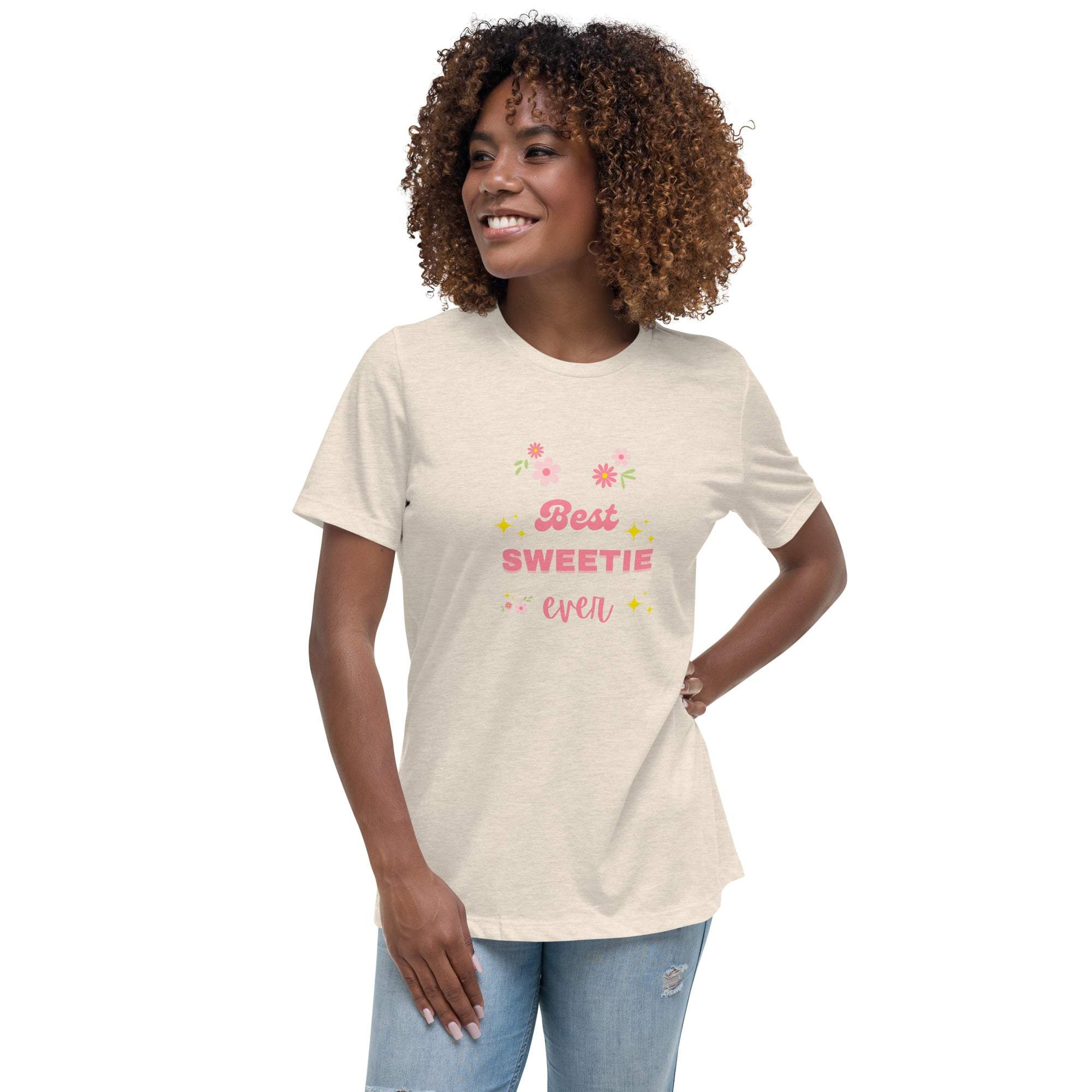 Woman wearing a beige "Best Sweetie Ever" t-shirt with floral and star accents, styled casually with jeans