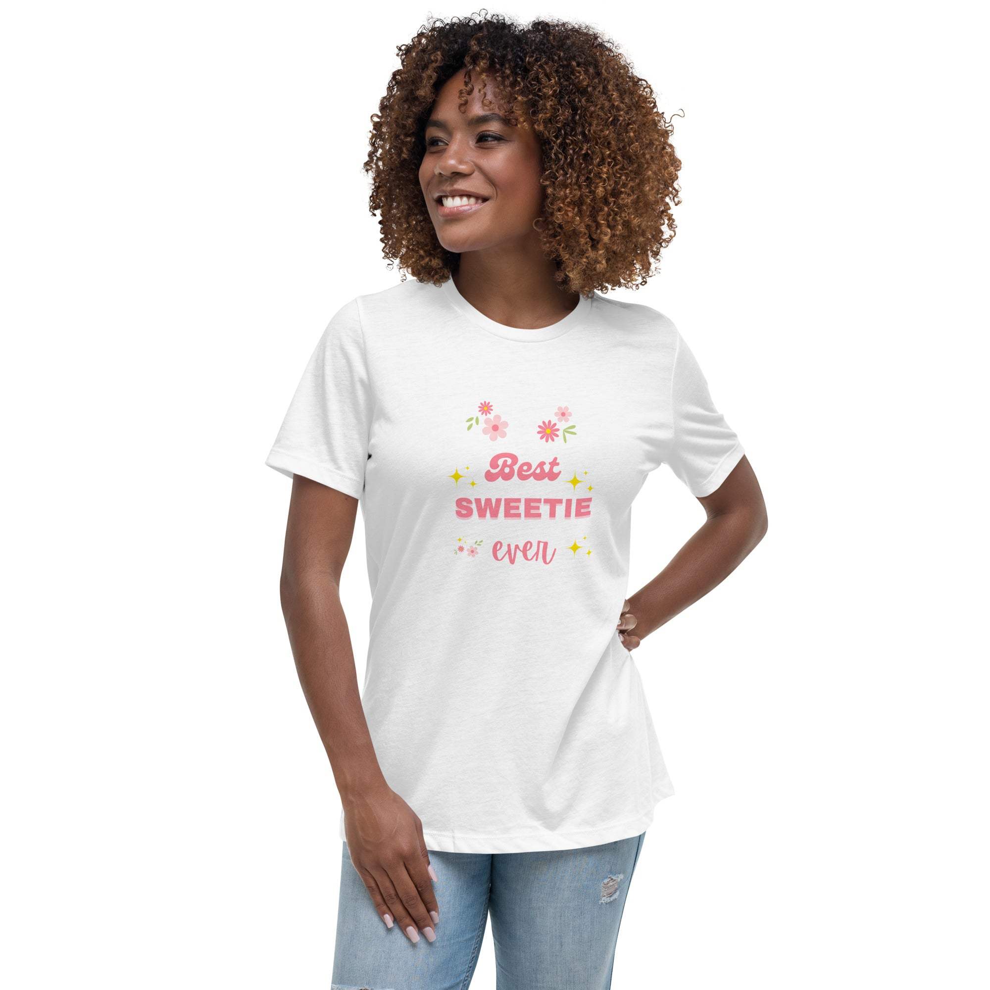 Woman wearing white "Best Sweetie Ever" t-shirt with floral and star designs, paired with light blue jeans.