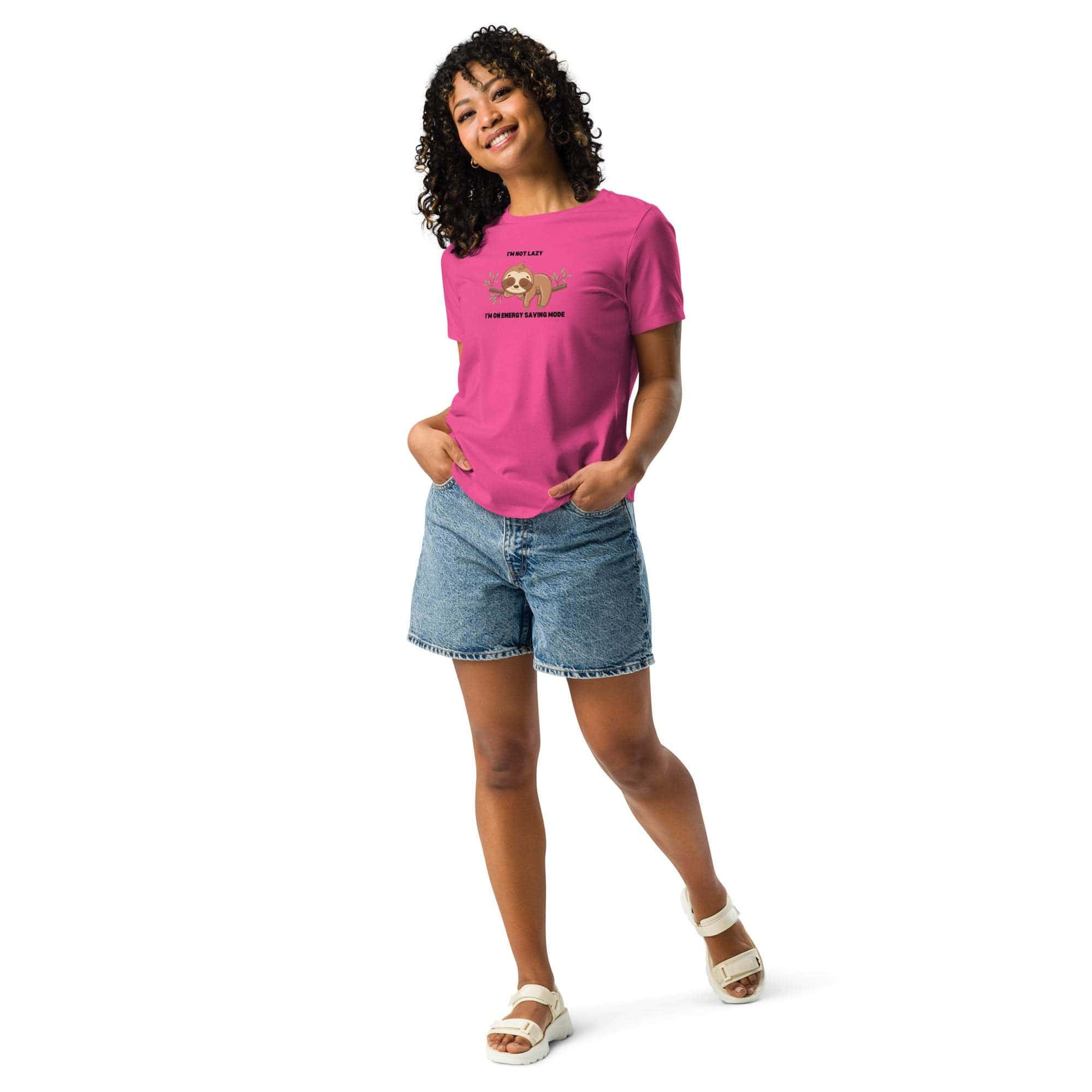 Woman wearing a pink relaxed fit Sloth T-shirt with "I'm Not Lazy, I Am On Energy Saving Mode" caption paired with denim shorts and white sandals