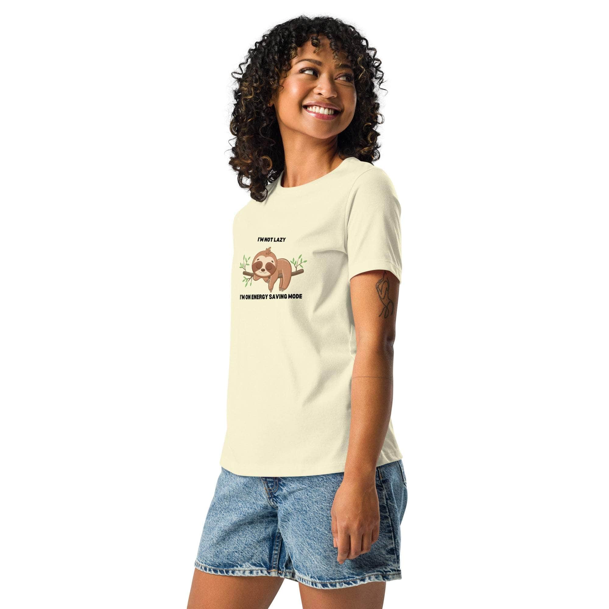 Woman wearing a beige sloth t-shirt with "I'm Not Lazy, I Am On Energy Saving Mode" text and sloth graphic paired with denim shorts