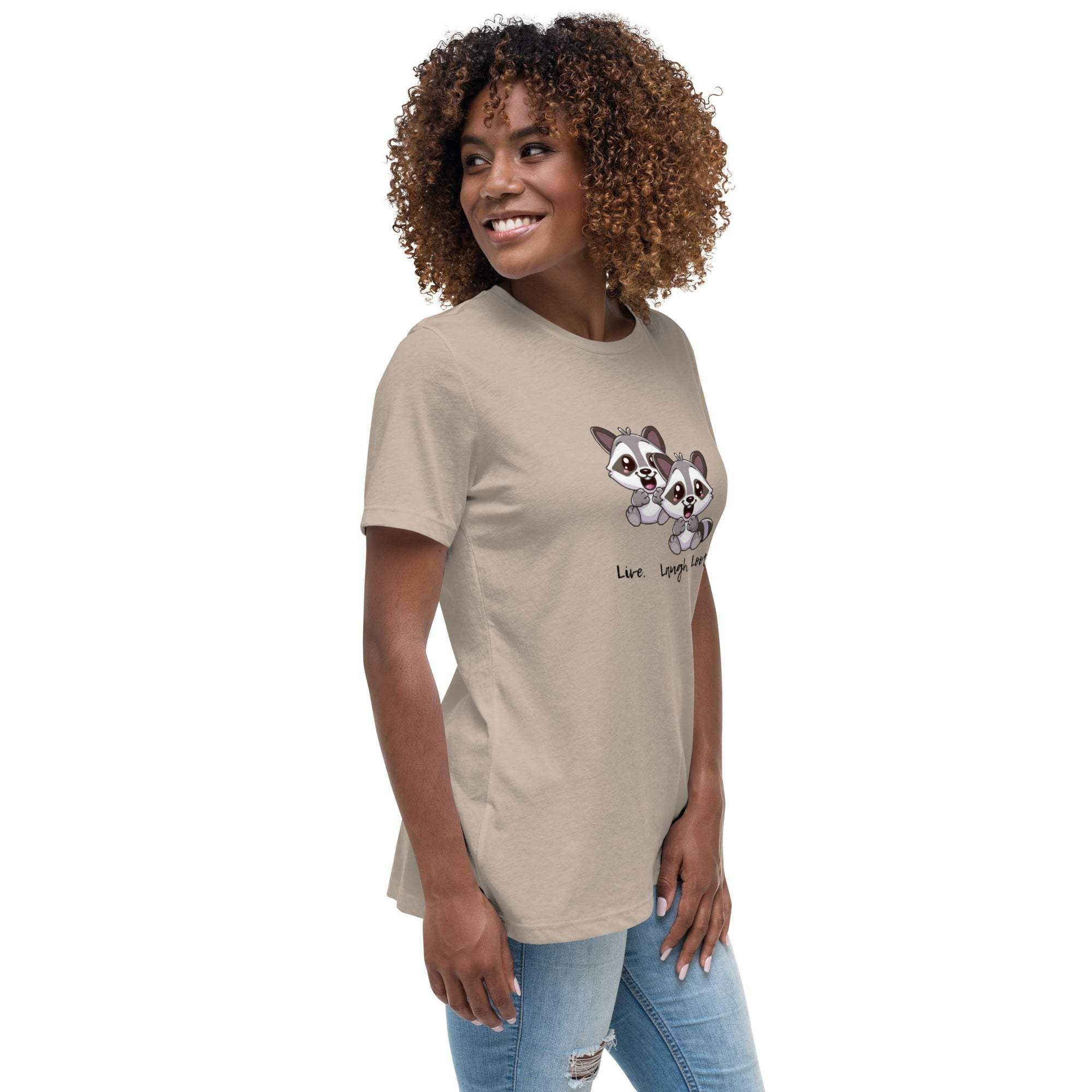Woman wearing beige Live Laugh Loot T-Shirt with cute raccoon graphic and text on front.