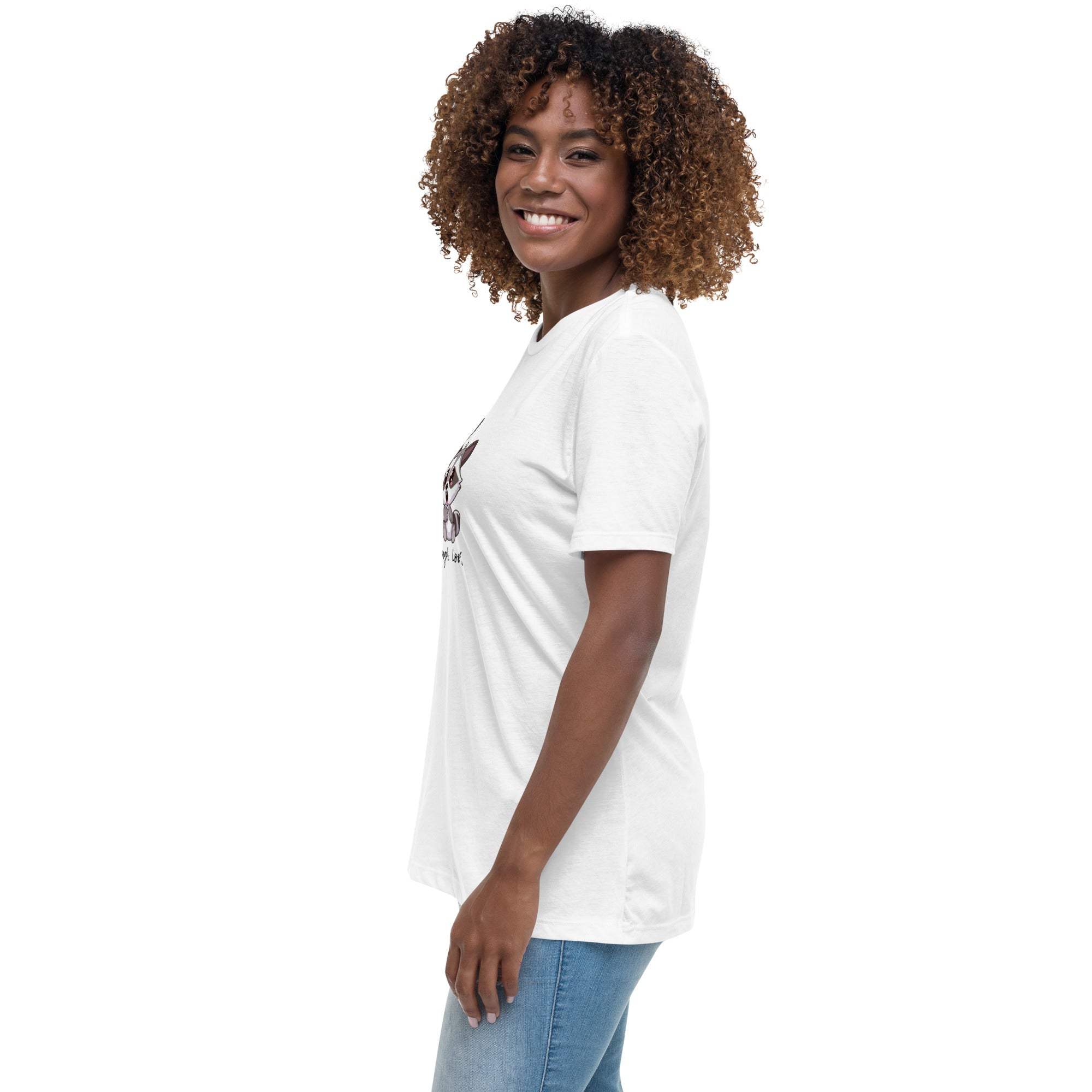 Woman wearing white Live Laugh Loot T-Shirt with raccoon graphic, paired with blue jeans, side view.
