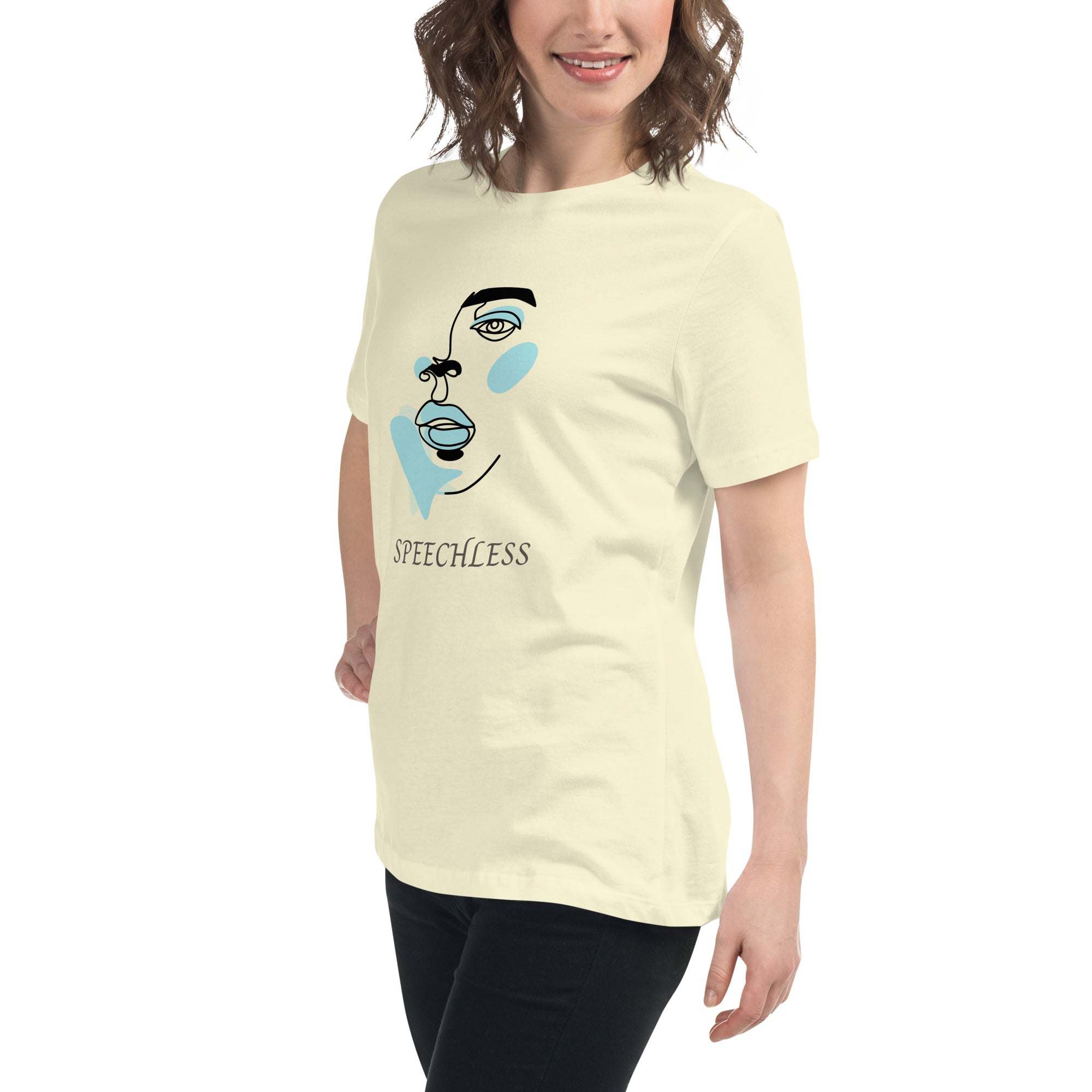Woman wearing a beige t-shirt with minimalist speechless face line art and abstract blue accents, paired with black pants