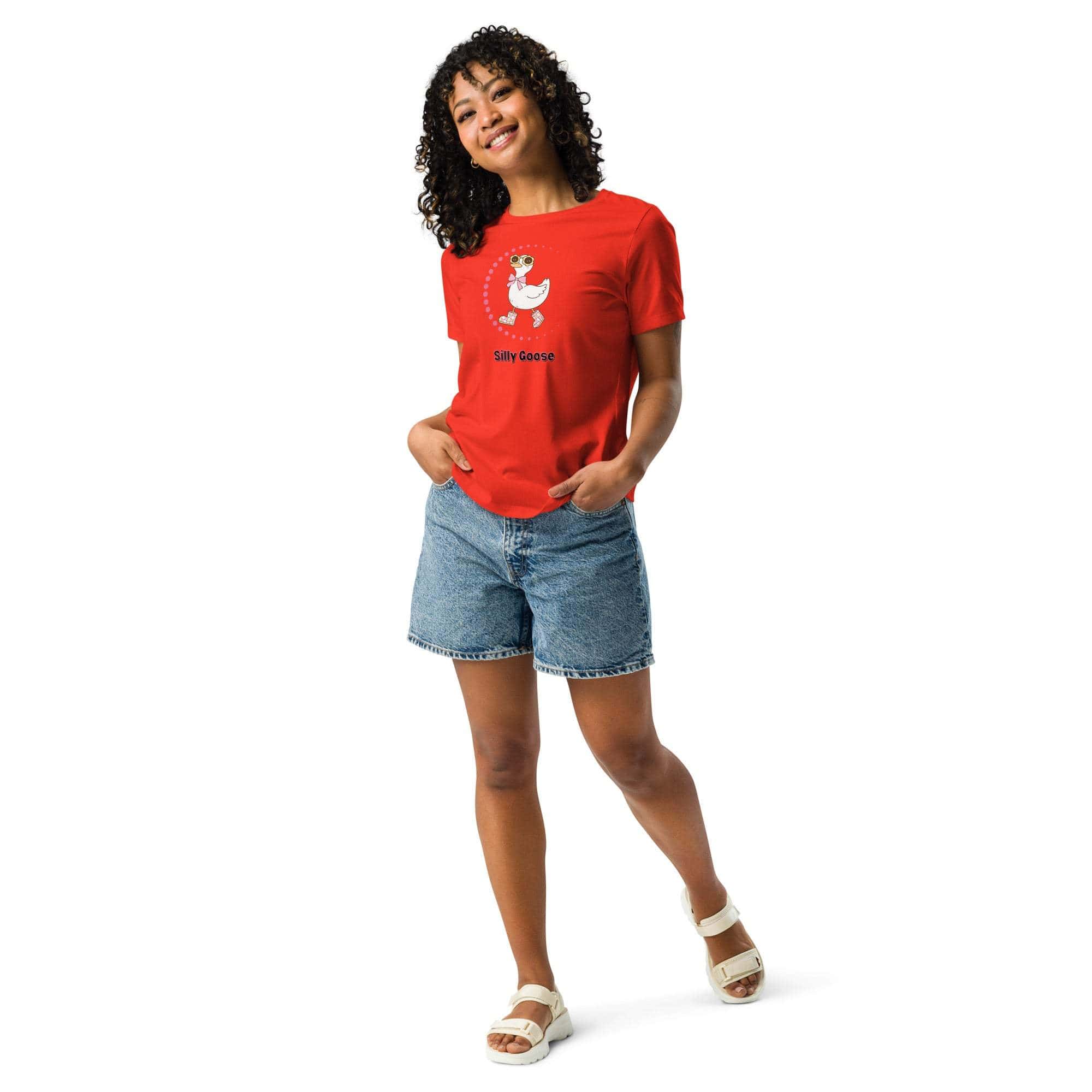 Woman wearing a red Silly Goose Graphic T-Shirt with a playful goose illustration and text, paired with denim shorts and white sandals.