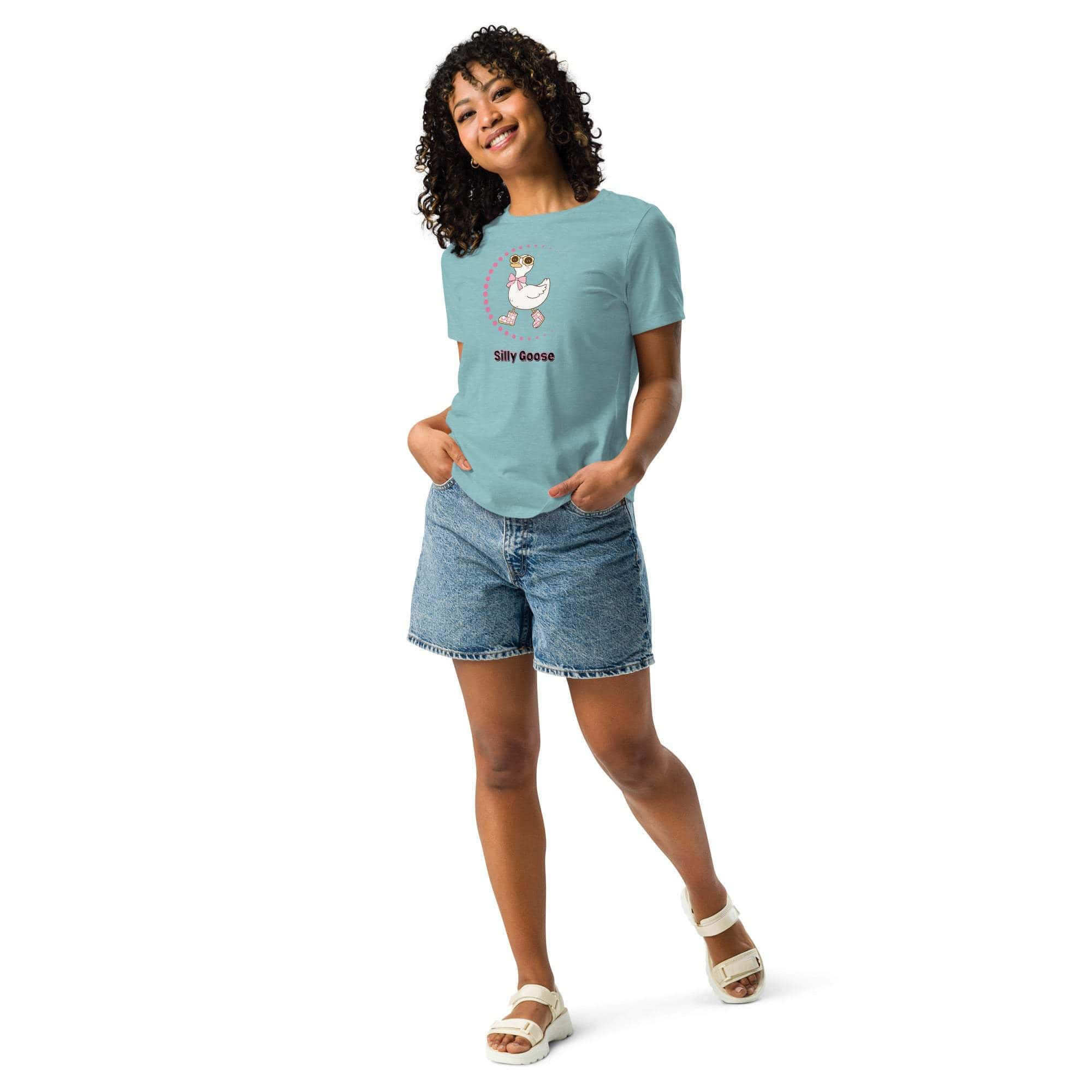 Woman wearing a light blue Silly Goose Graphic T-Shirt with a playful illustrated goose and text, paired with denim shorts and white sandals.