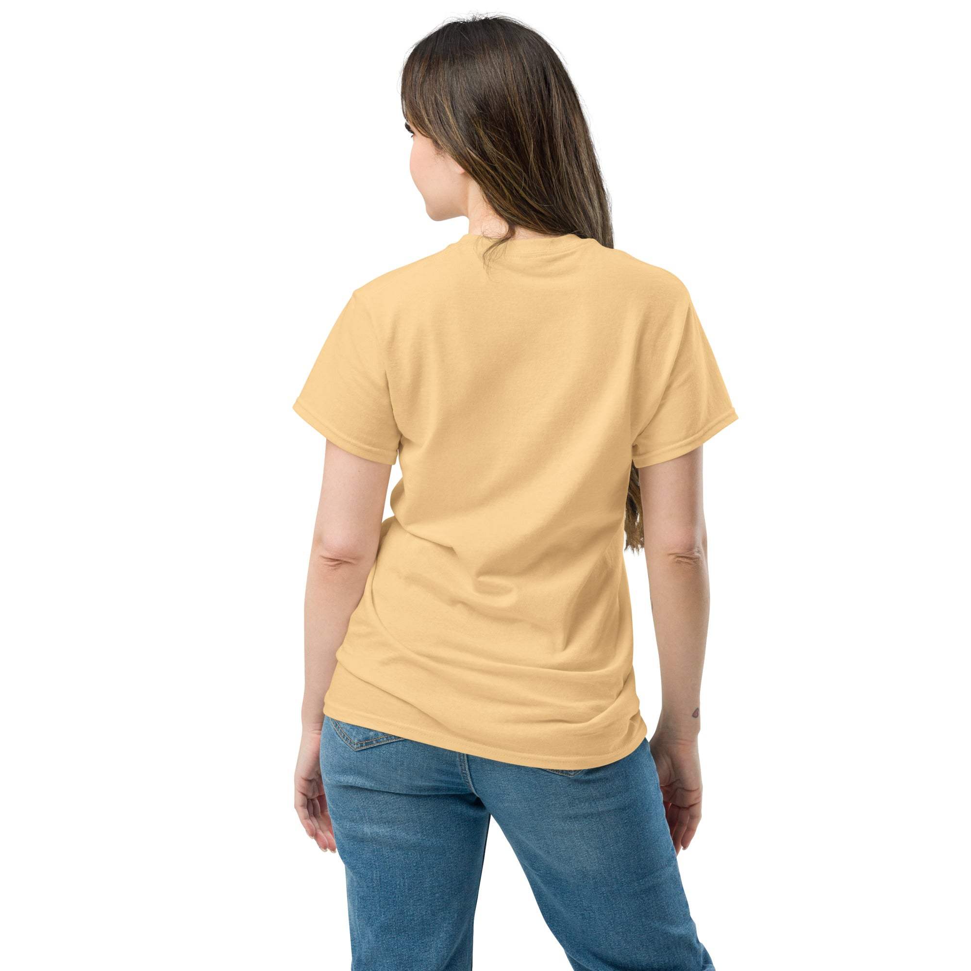 Woman wearing beige Christian Cross T-Shirt viewed from the back, paired with blue jeans