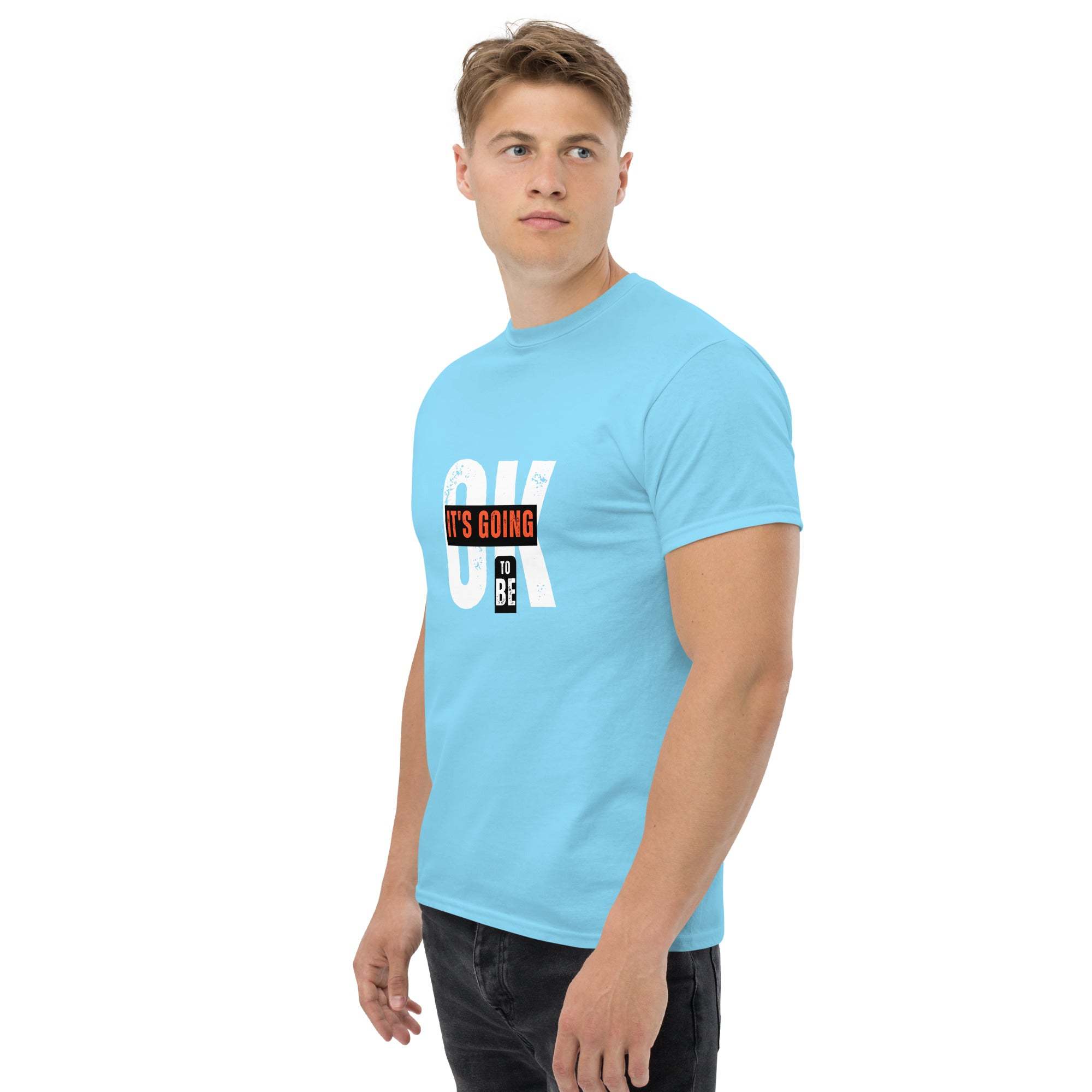 Young man wearing a light blue trendy graphic t-shirt with motivational quote, casual summer streetwear style
