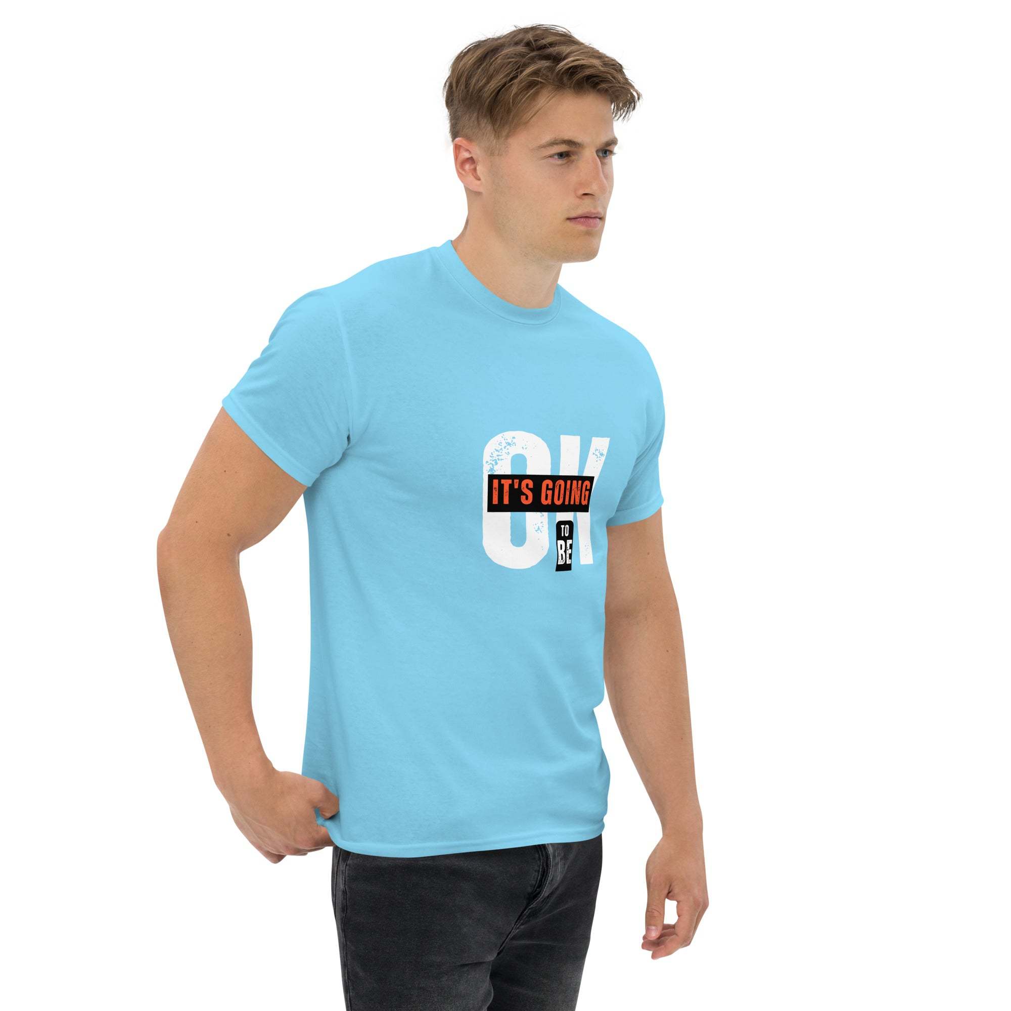 Man wearing light blue trendy graphic t-shirt with motivational quote on front, styled for casual streetwear.