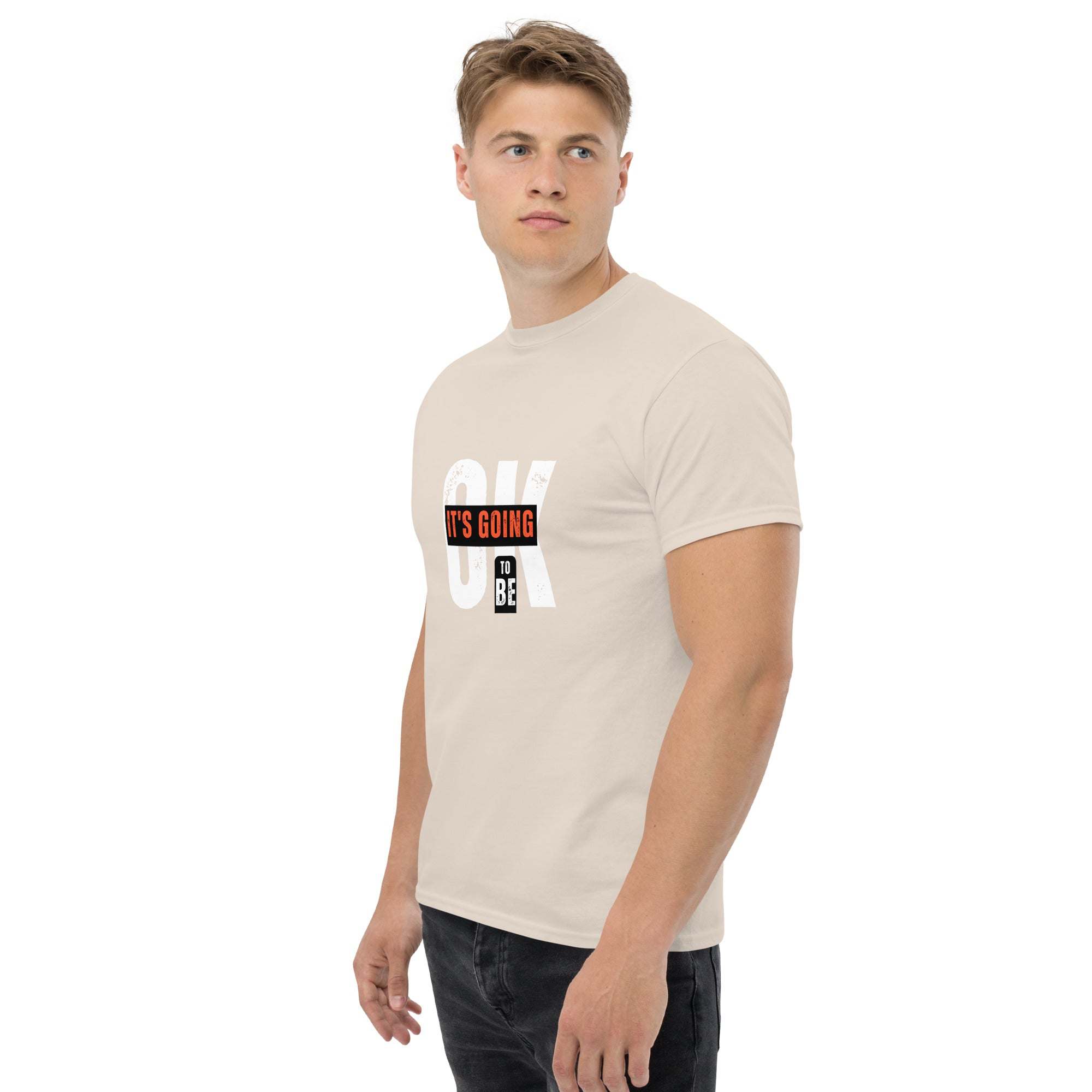 Man wearing beige trendy graphic t-shirt with motivational quote print and short sleeves in casual streetwear style