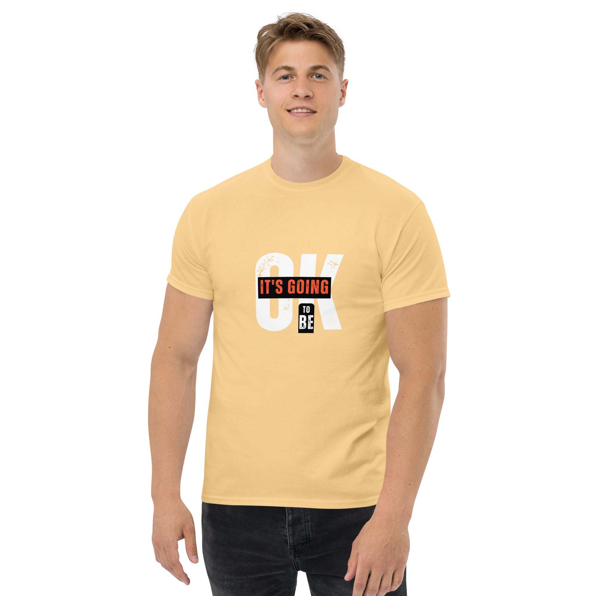 man wearing yellow trendy graphic t-shirt with motivational quote "OK IT'S GOING TO BE" on front