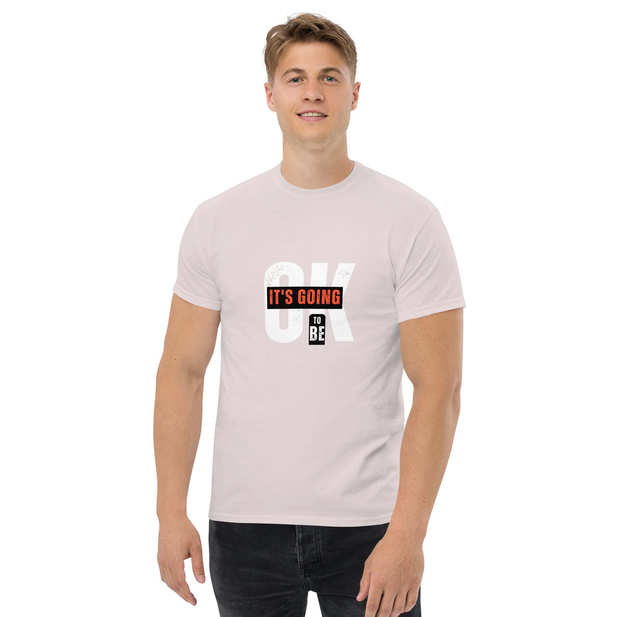Man wearing trendy graphic t-shirt with motivational quote "It's going to be OK" in casual street style