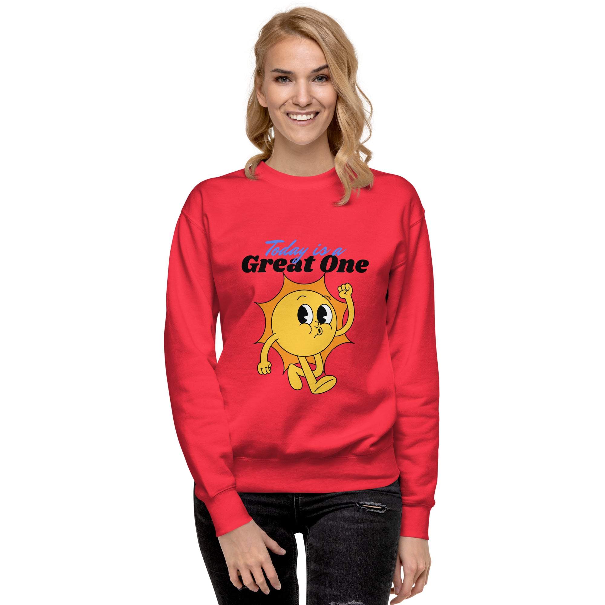 Woman wearing red Positive Sun Sweatshirt with cheerful sun graphic and motivational "Today is a Great One" text, casual fit and crewneck style