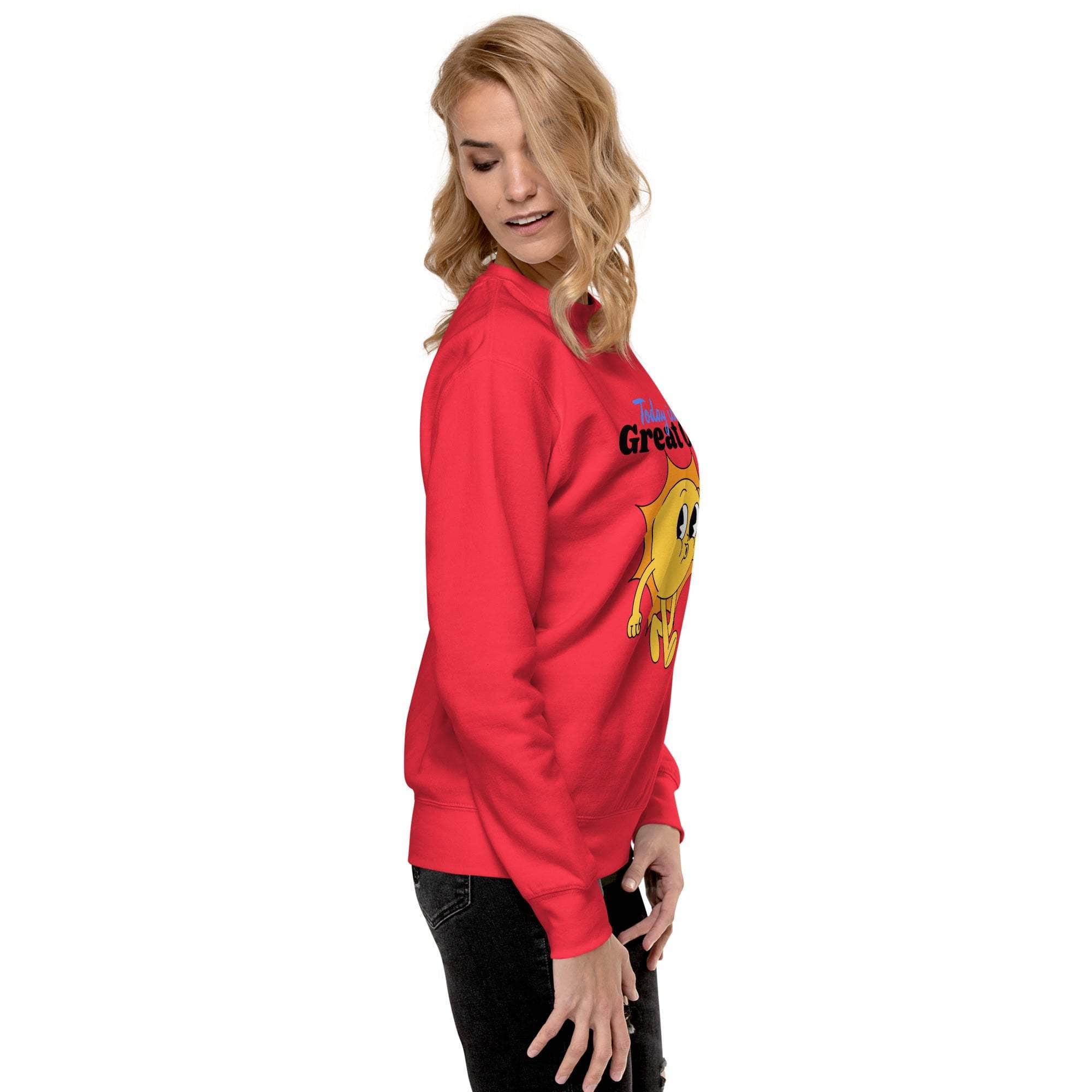 Woman wearing red Positive Sun Sweatshirt with cheerful sun graphic and motivational quote, side view