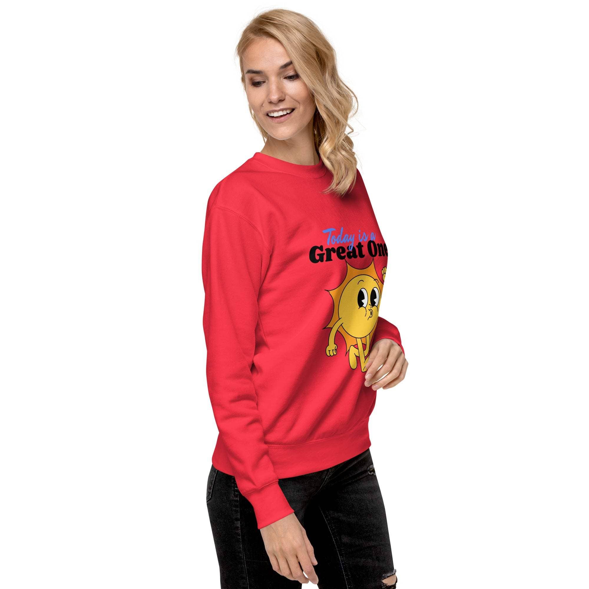 Woman wearing a red Positive Sun Sweatshirt with a cheerful sun graphic and motivational text "Today is a Great One" in casual outfit