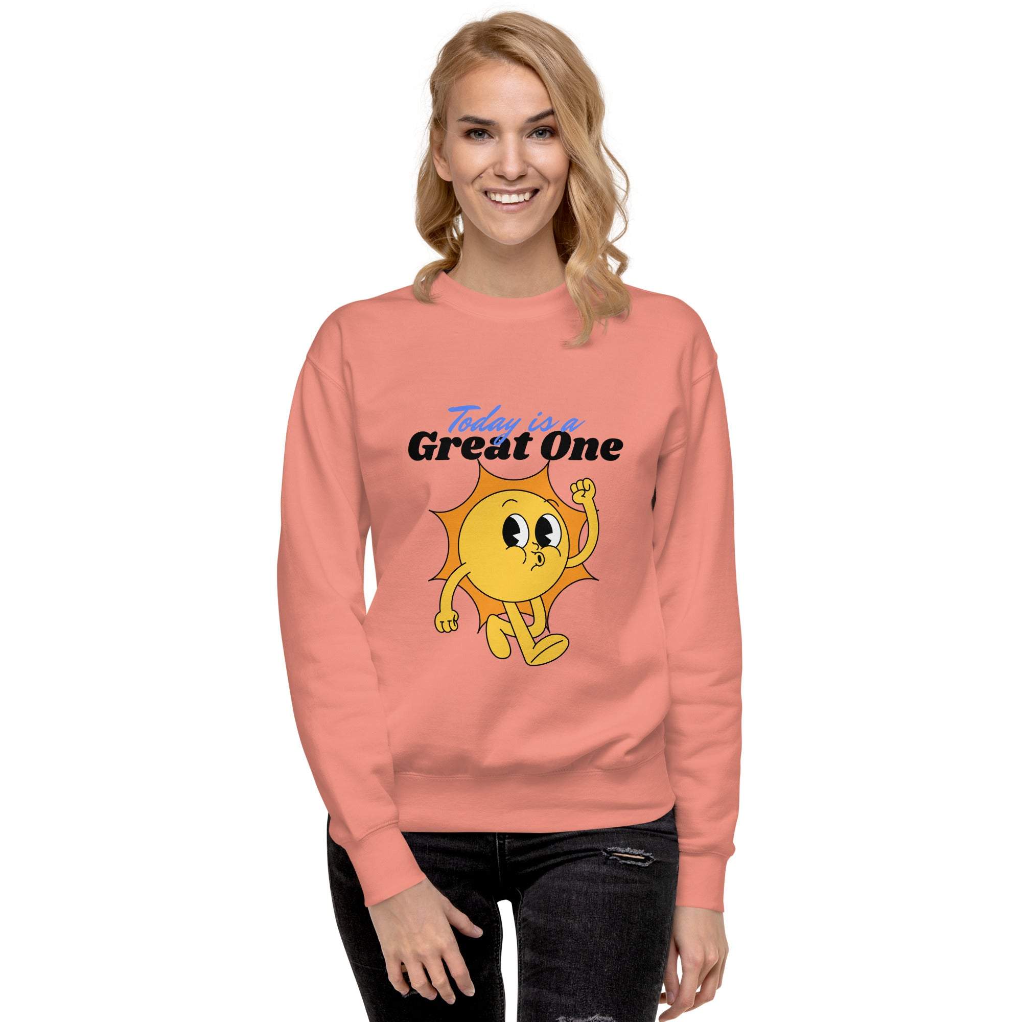 Woman wearing a coral Positive Sun Sweatshirt with a cheerful sun graphic and "Today is a Great One" motivational text