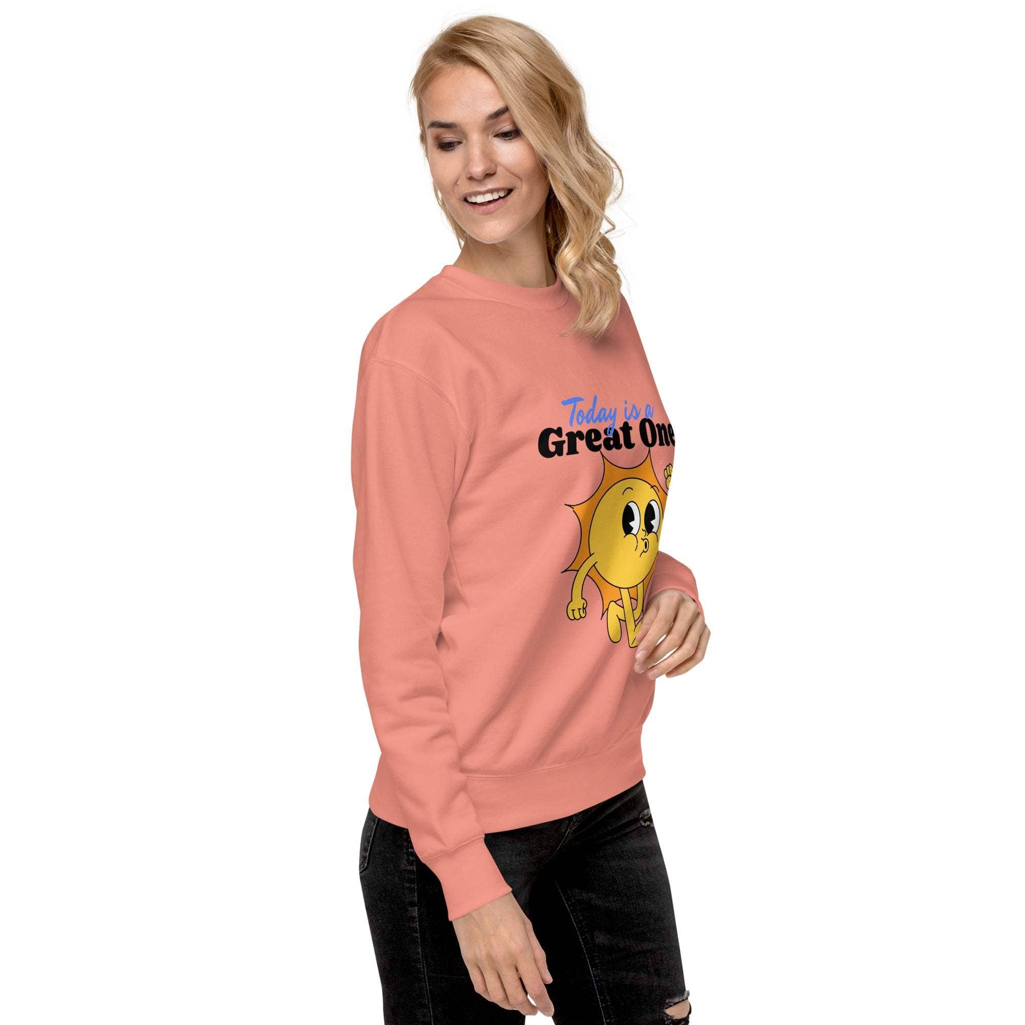 Woman wearing Positive Sun Sweatshirt with cheerful sun graphic and motivational quote in coral color