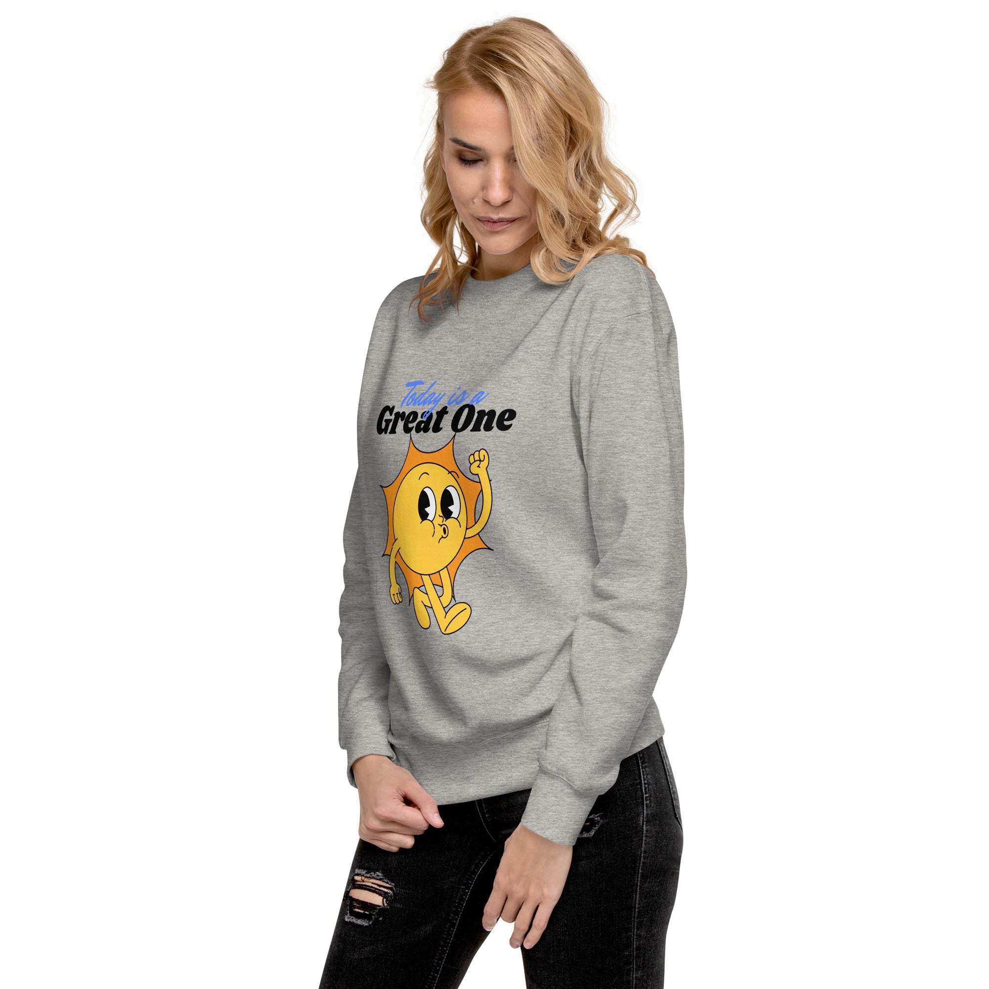 Woman wearing a grey Positive Sun Sweatshirt with a cheerful sun graphic and motivational text "Take the Great One"