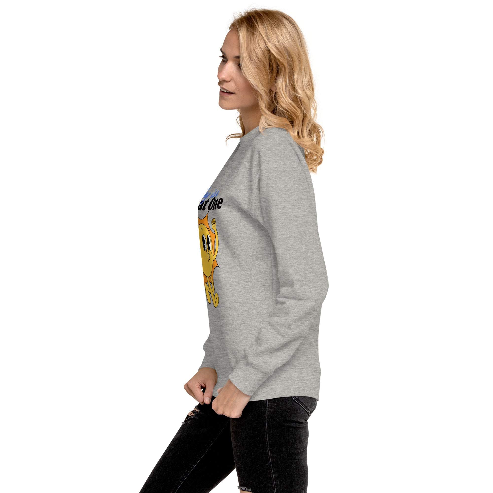 Side view of woman wearing grey Positive Sun Sweatshirt with cheerful sun graphic and motivational quote