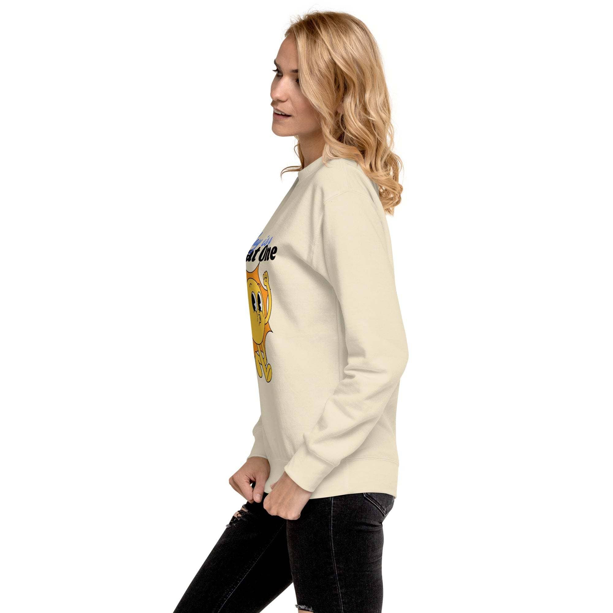 Woman wearing beige Positive Sun Sweatshirt with motivational sun graphic, side view, casual outfit