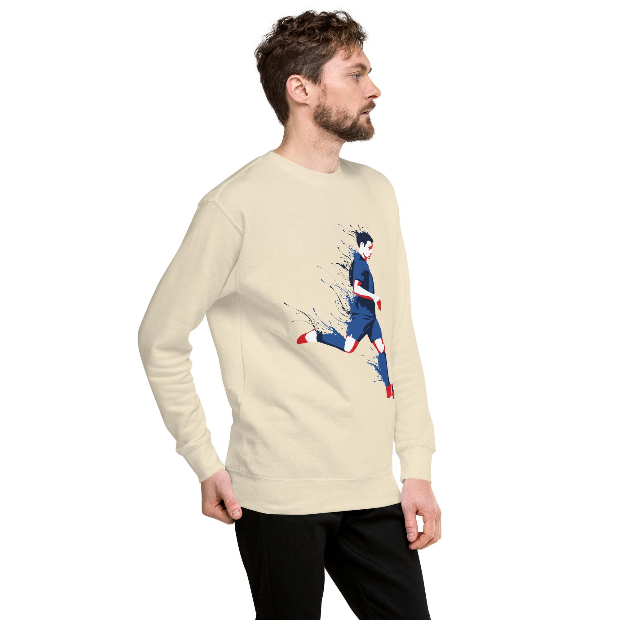 Man wearing beige soccer player sweatshirt with dynamic graphic of a soccer player in blue and red running