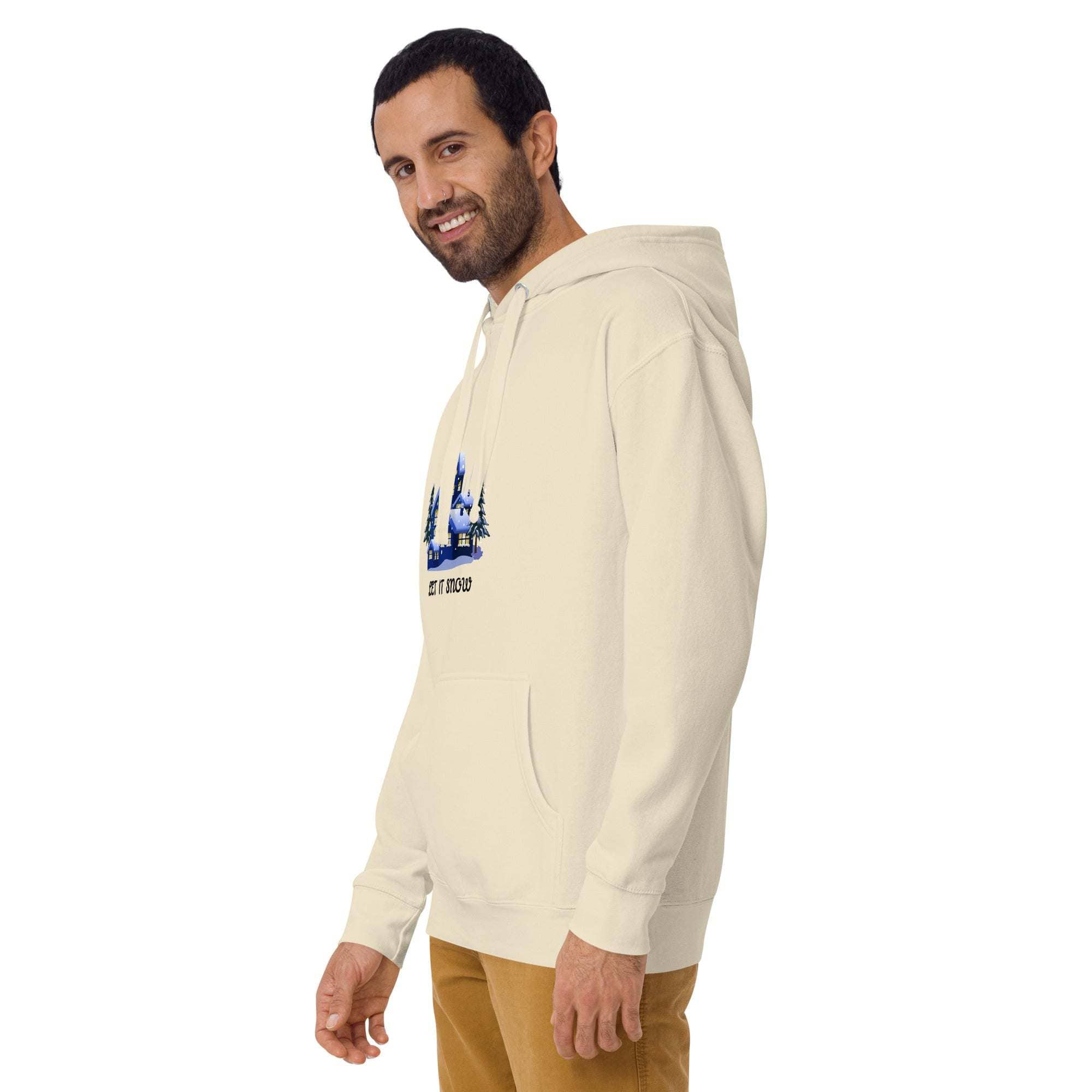 Man wearing cream Let It Snow Hoodie with snowy village print and front pocket