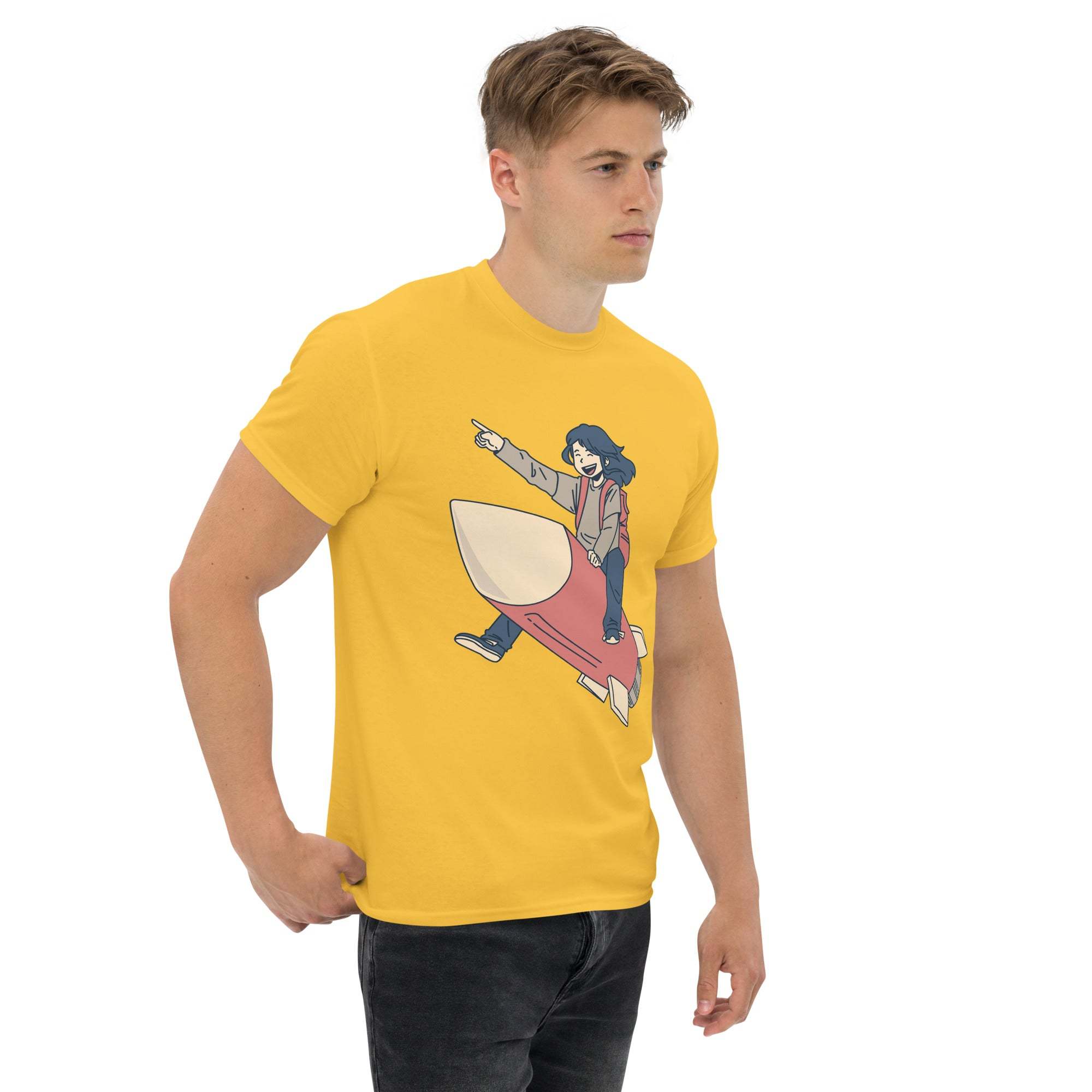 Man wearing yellow Rocket Ride T-Shirt with retro cartoon astronaut graphic pointing forward