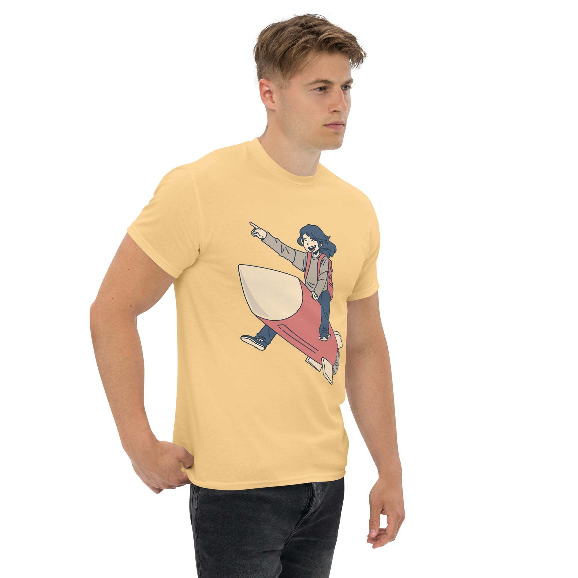 Man wearing yellow Rocket Ride T-Shirt with retro cartoon astronaut and rocket graphic