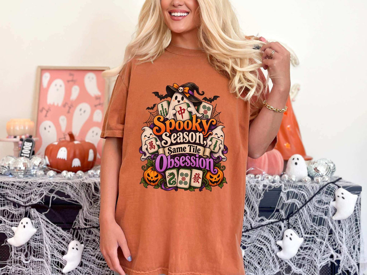 Halloween graphic T-shirt in rust orange cotton with colorful ghosts, pumpkins, bats, and mahjong tiles; What to Wear to a Halloween Mahjong Night
