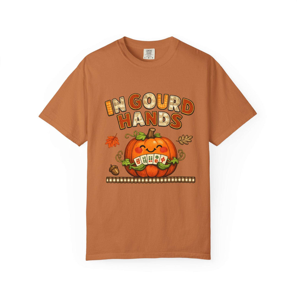 A rust-orange crewneck t-shirt featuring a Halloween graphic with the text 'IN CLOUD HANDS' above a smiling orange pumpkin holding a sign that says 'OH EA' with a '9' in place of an 'A'. The shirt is displayed flat against a clean white background.