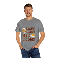 White cotton t-shirt featuring 'Praise the Lord, Devil the Eggs' design, perfect for Easter and Christian apparel.