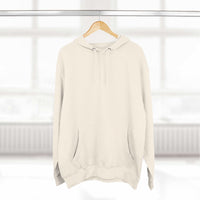 Cozy beige fleece hoodie with adjustable hood and kangaroo pocket hanging on wooden hanger in bright room
