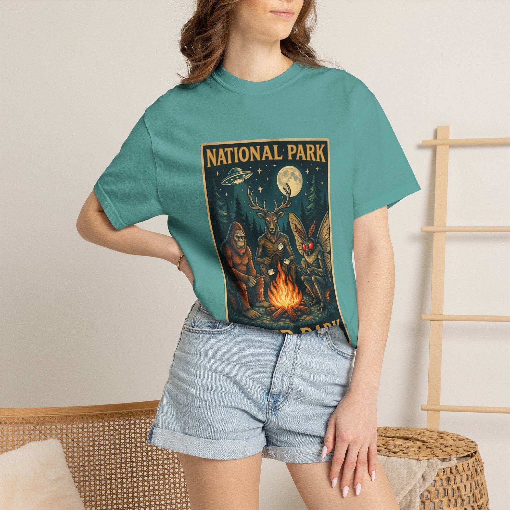 National Park After Dark T-shirt with campfire, Sasquatch, and Mothman night creatures design on vintage-style fabric