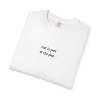White t-shirt with 'rest is part of the plan' text on a white background