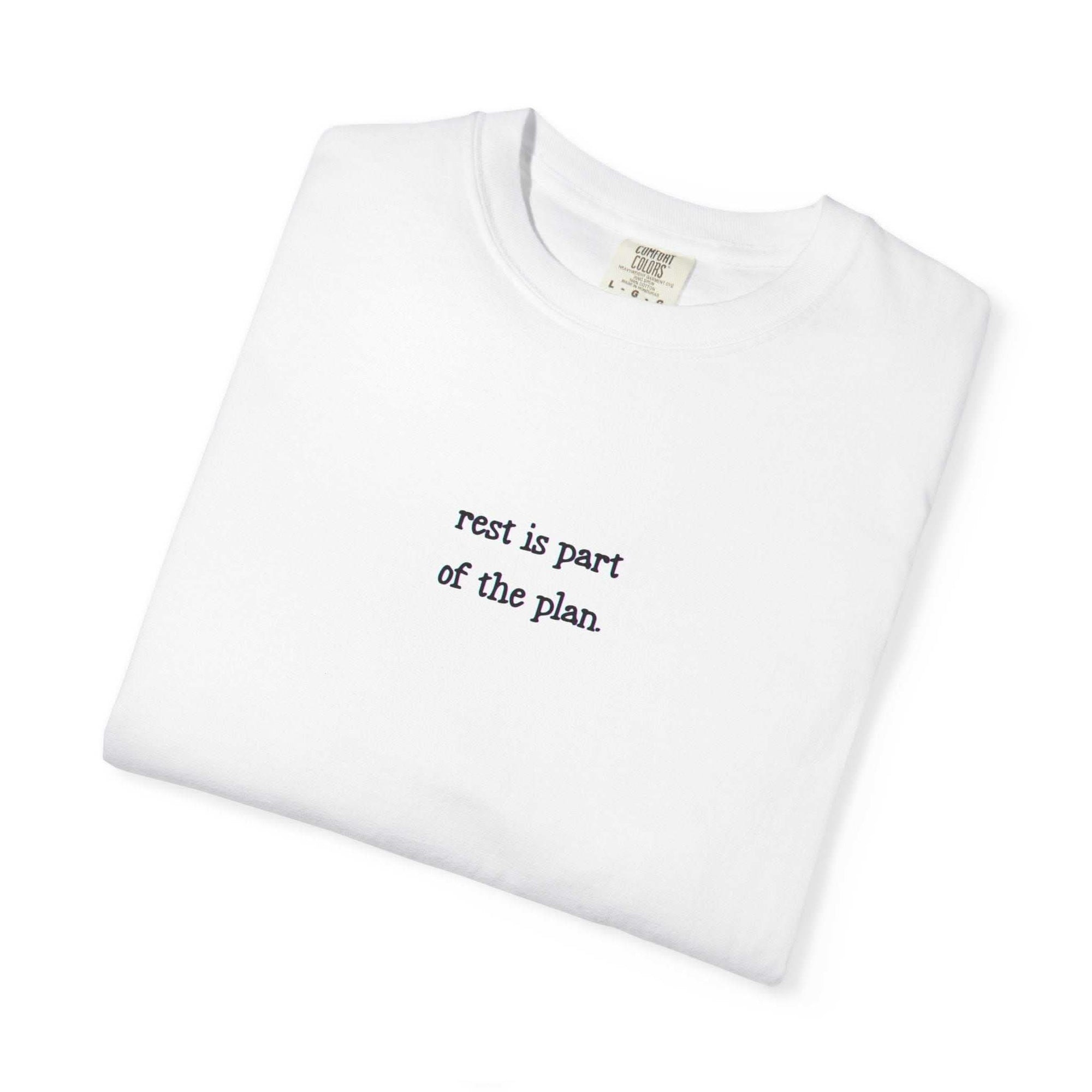 White t-shirt with 'rest is part of the plan' text on a white background