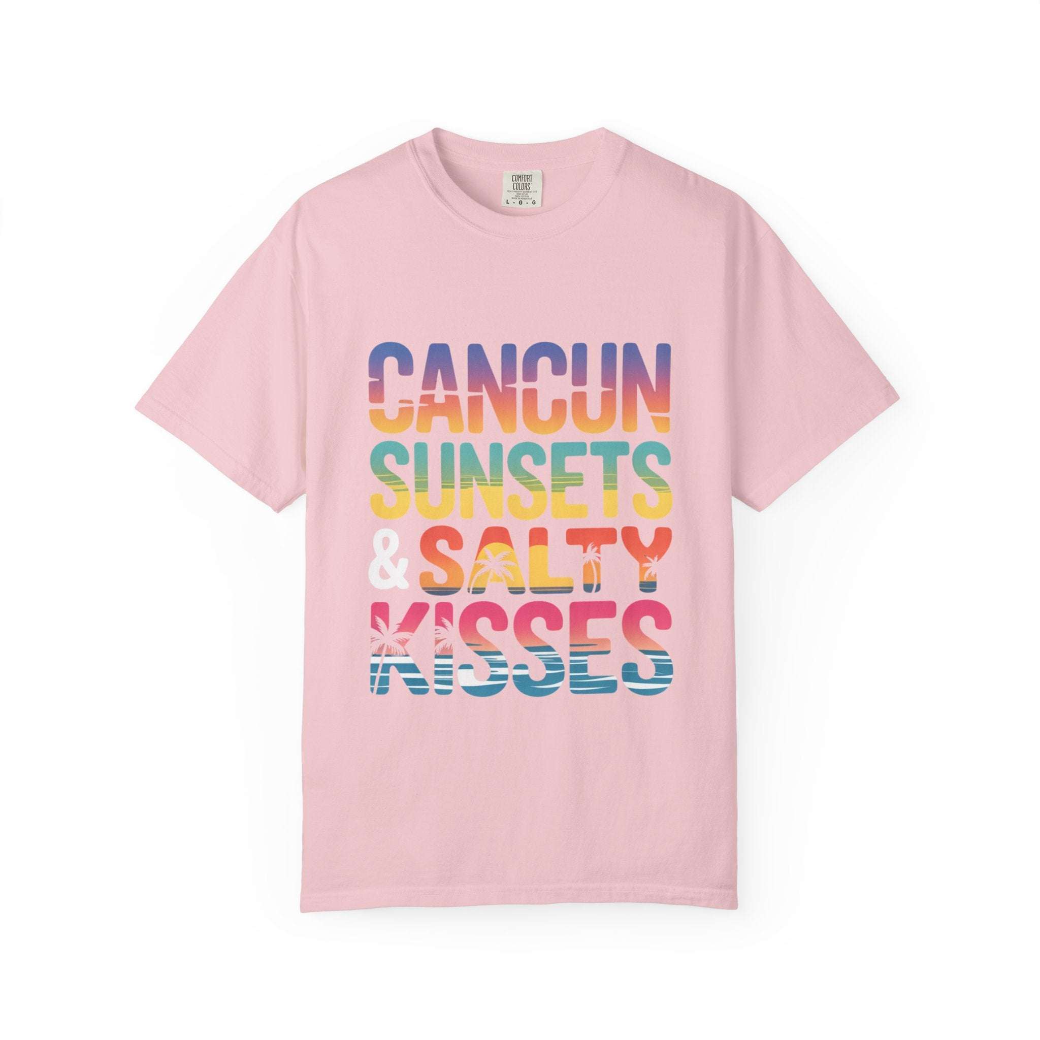 Pink t-shirt with colorful text 'Cancun Sunsets & Salty Kisses' on a white background