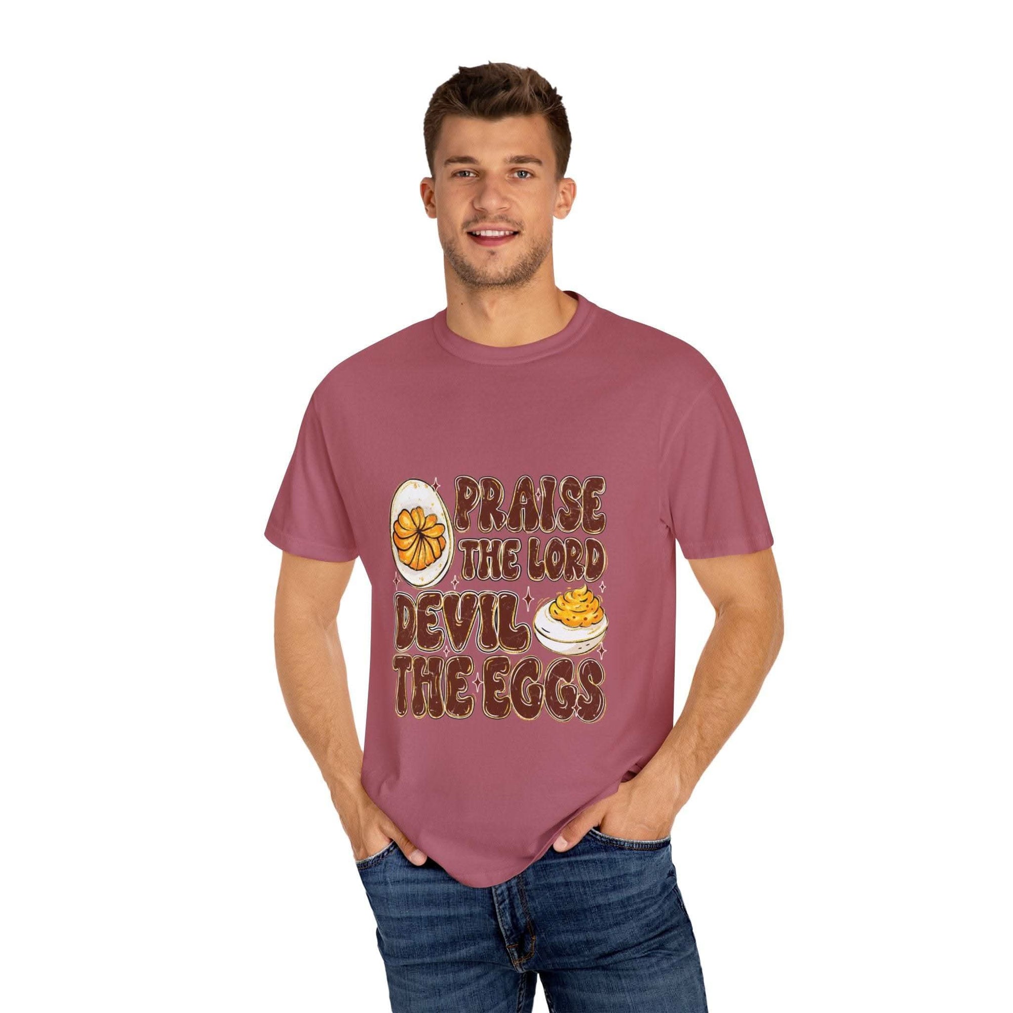 White cotton t-shirt featuring 'Praise the Lord, Devil the Eggs' design, perfect for Easter and Christian apparel.