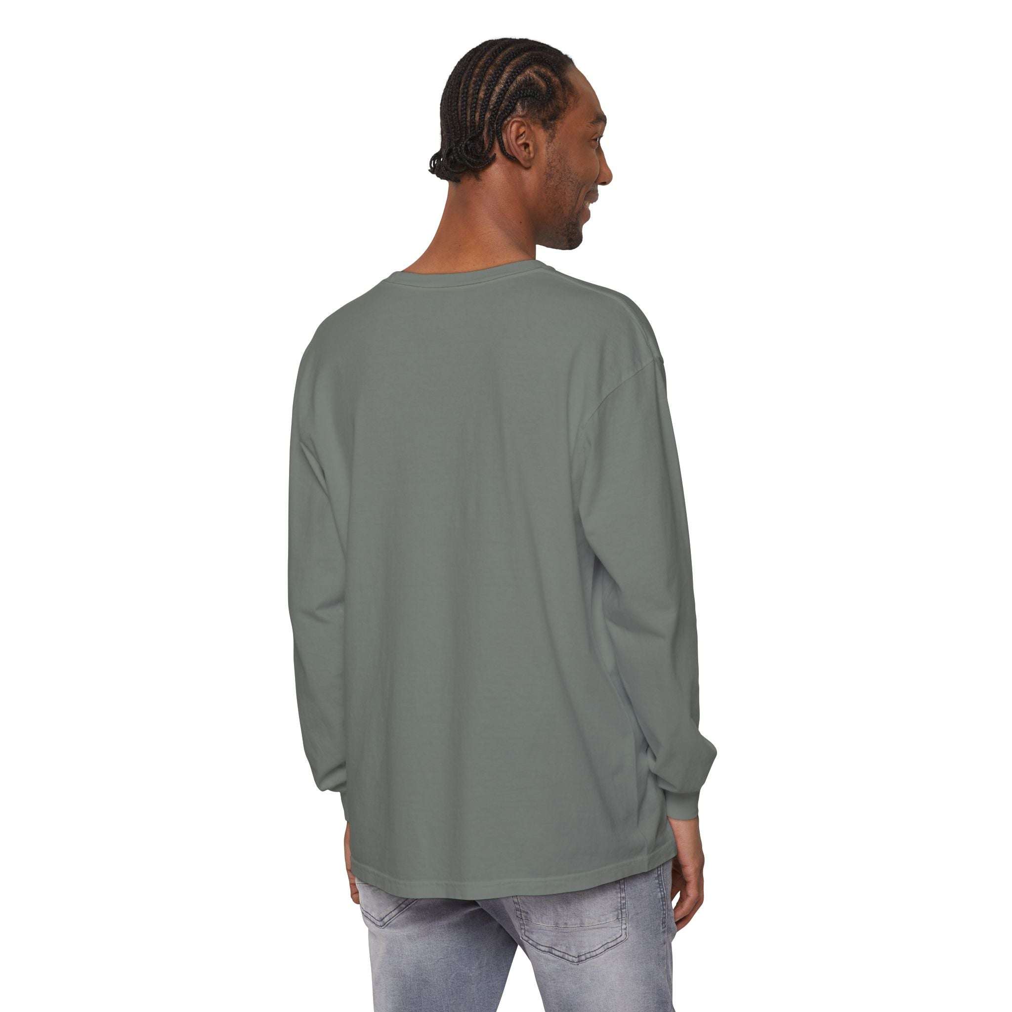 Back view of man wearing solid color long sleeve t-shirt with ribbed cuffs and relaxed fit