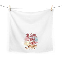 White kitchen towel with "Baking Spirits Bright" text, rolling pin, and cookie design, 100% cotton, festive holiday theme
