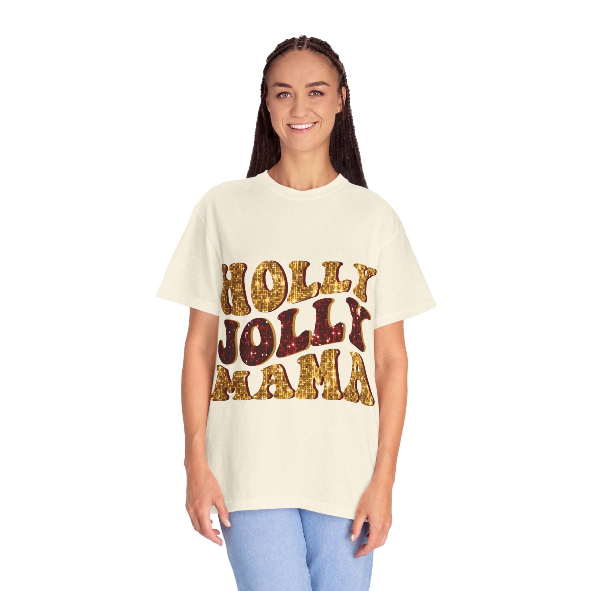 Woman wearing a white Faux Glitter Holly Jolly Mama t-shirt with gold glitter text and blue jeans