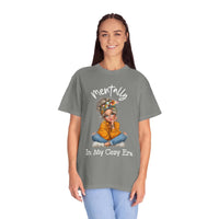 Woman wearing Mentally in My Cozy Era T-Shirt with graphic design of a girl sitting cross-legged and hand-lettered text on chest
