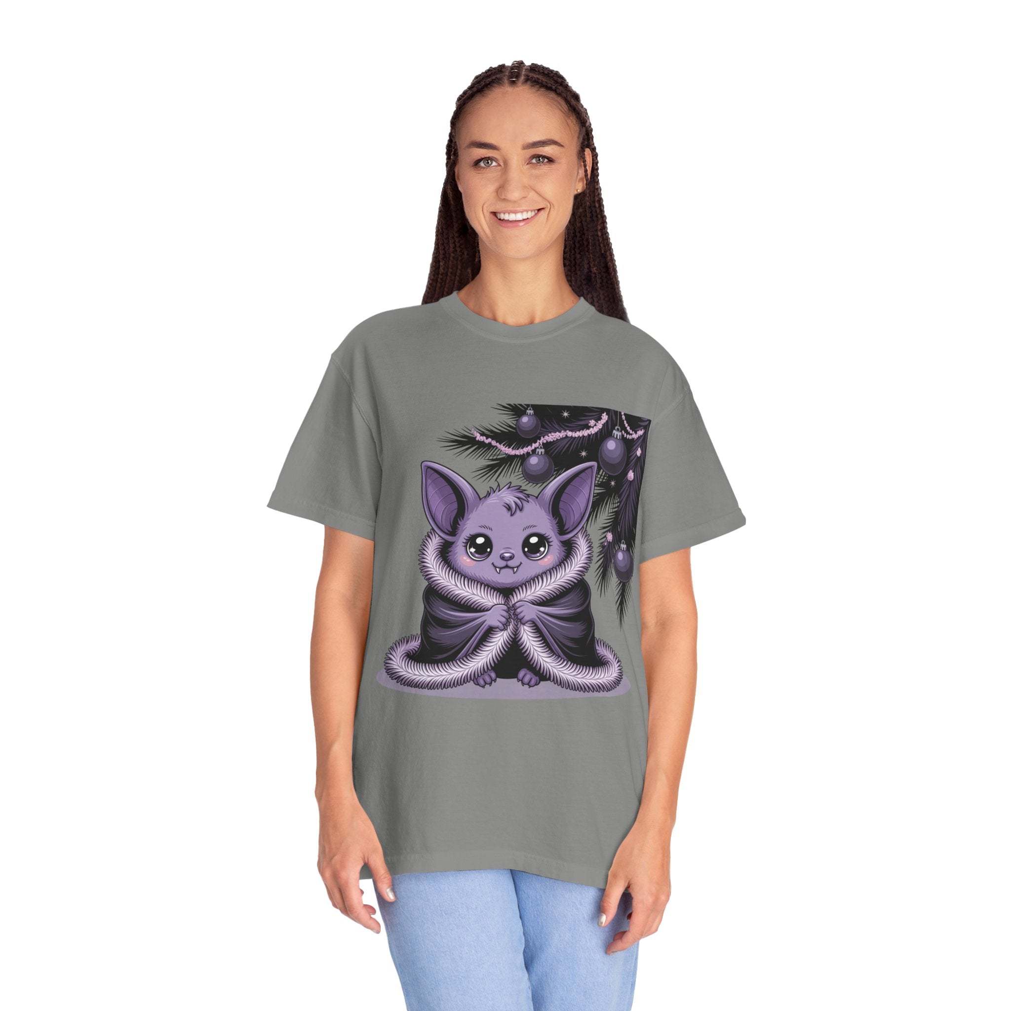 Person wearing a gray t-shirt with a purple creature graphic on a white background