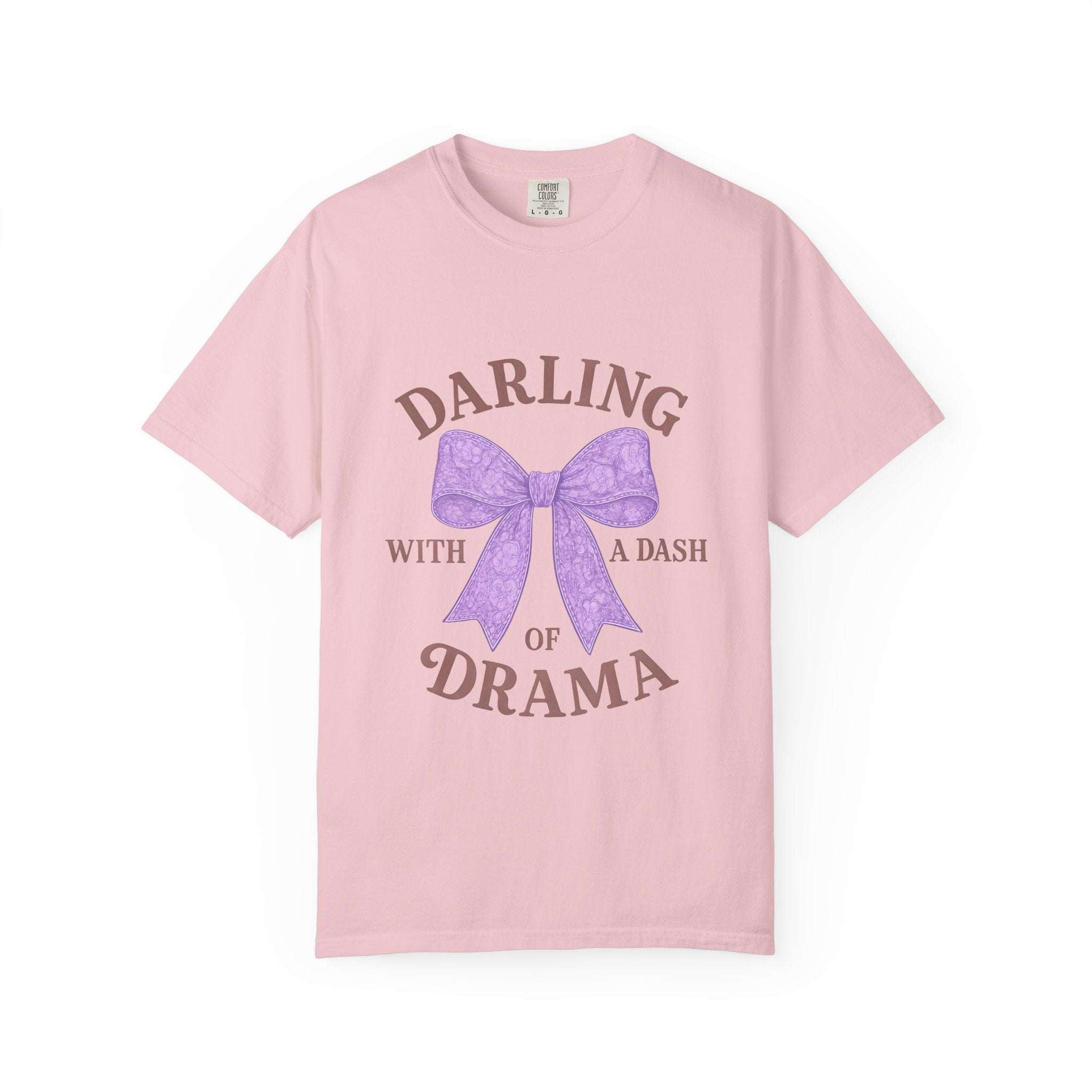 Pink t-shirt with a purple bow and text on a white background