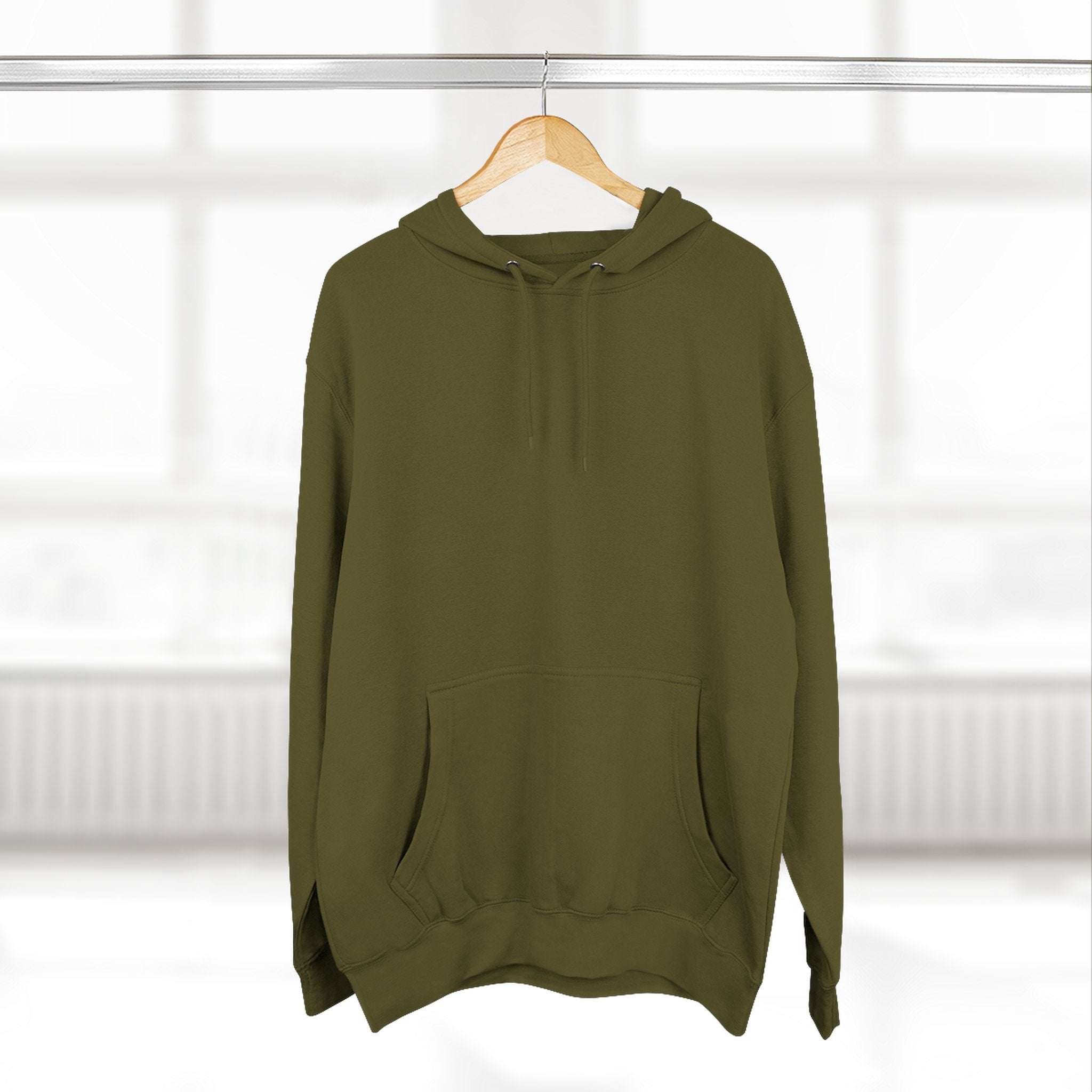 Olive green fleece hoodie with adjustable hood and kangaroo pocket hanging on wooden hanger in bright room