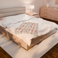 Velveteen plush blanket with retro Christmas frames on a bed in cozy bedroom setting